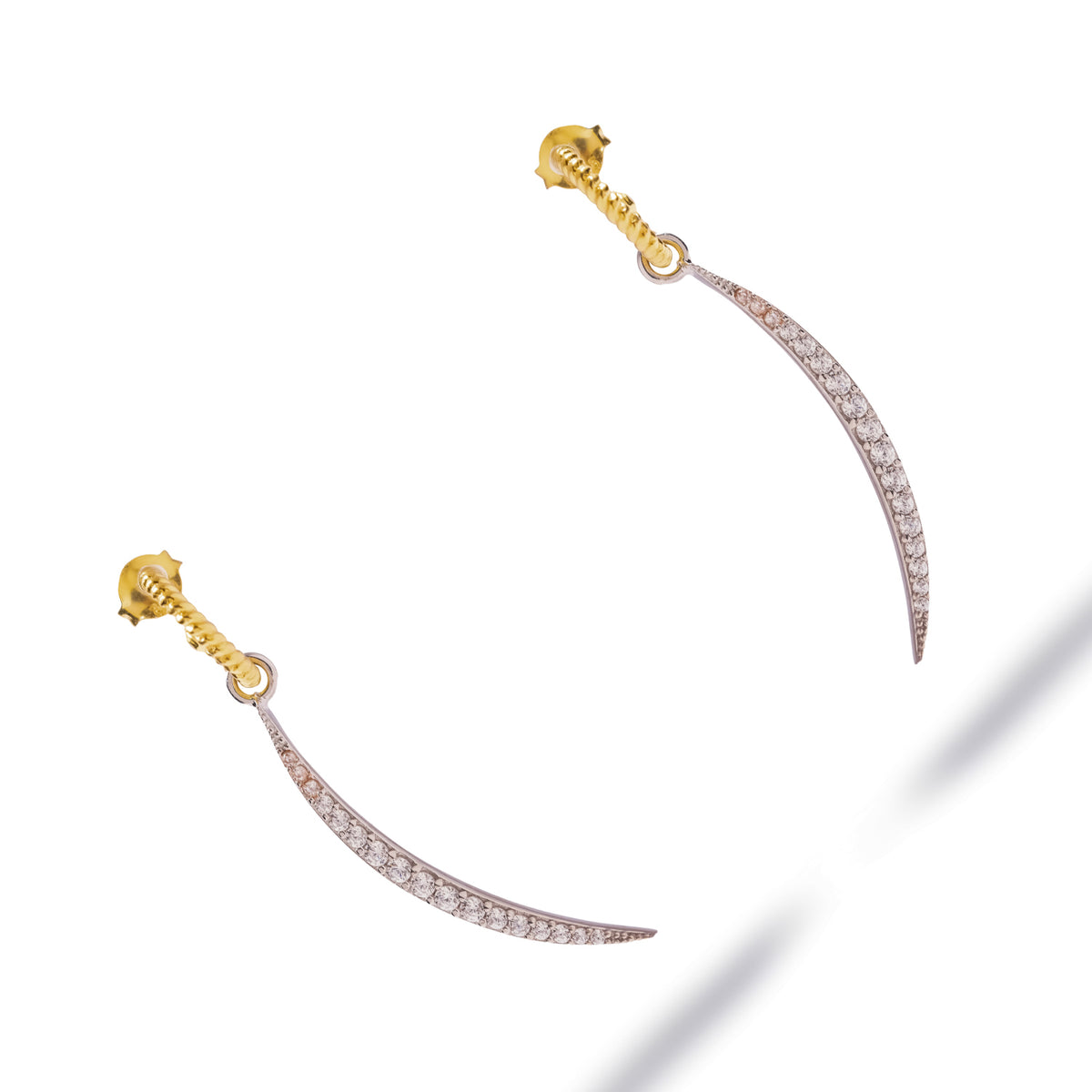 Gold twisted hoops and tapering sterling silver pave arcs, angled view of the pair