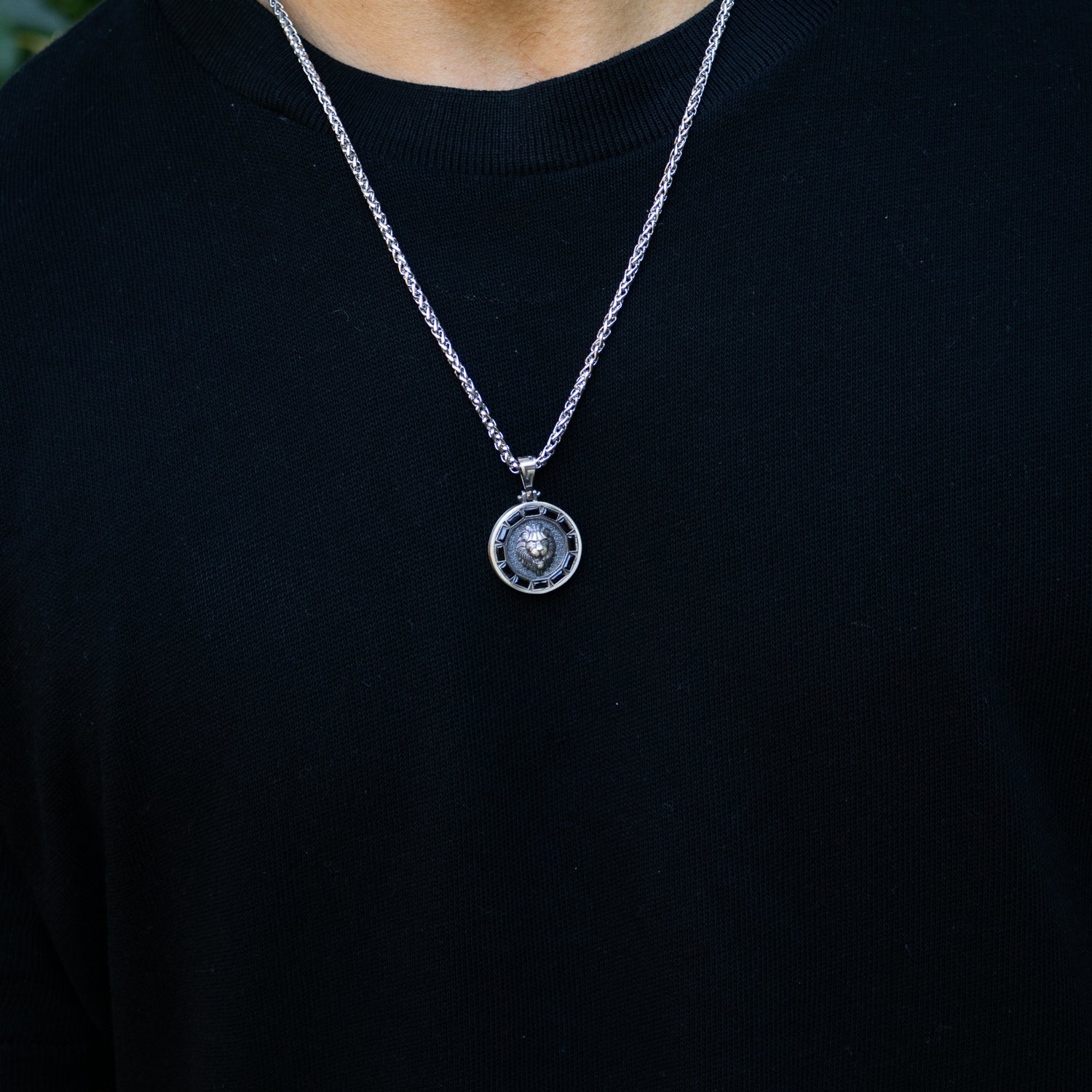 Sterling silver necklace with lion medallion pendant, pavé black CZ diamond eyes, rhodium finish, geometric features, masculine statement style.