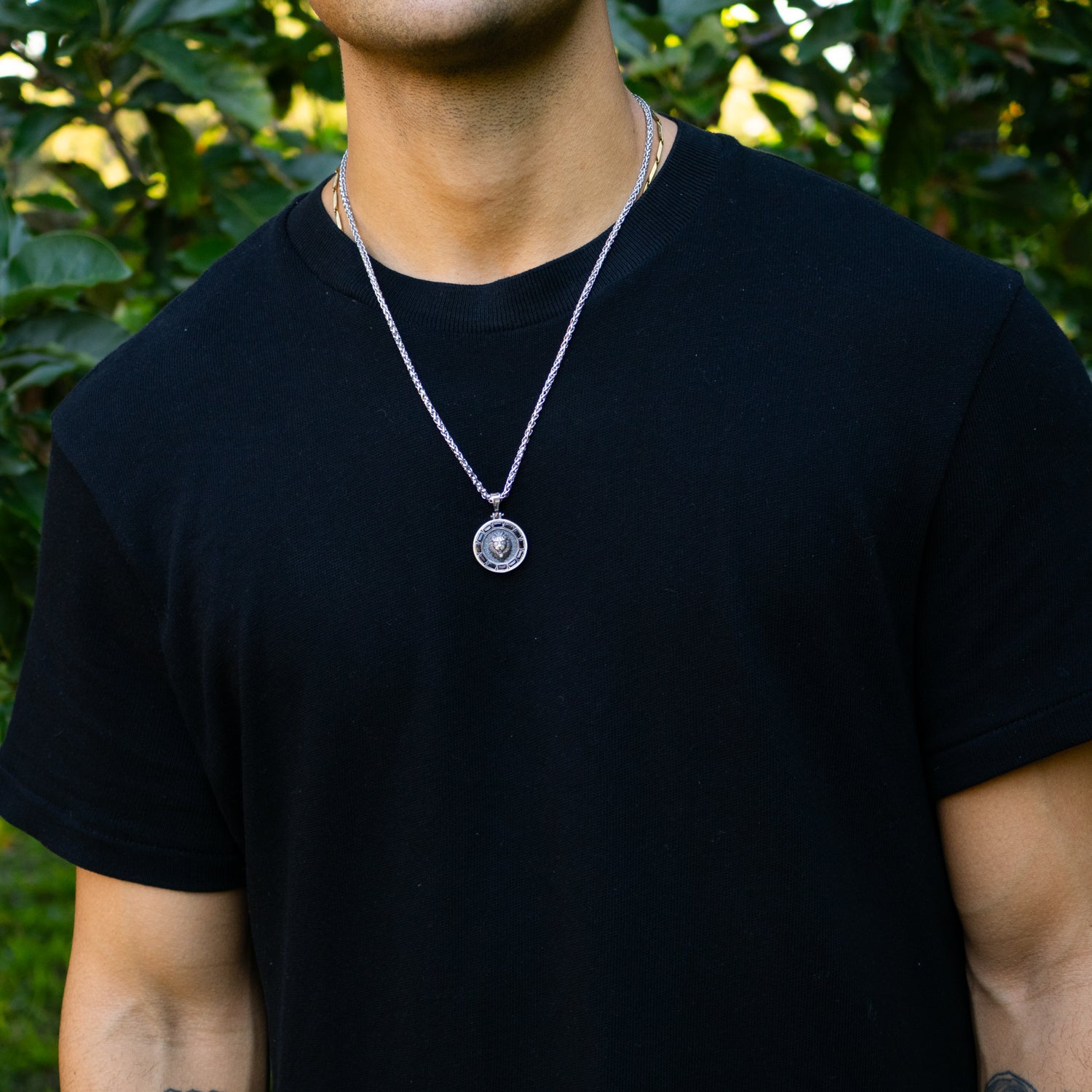 Sterling silver necklace with lion medallion pendant, pavé black CZ diamond eyes, rhodium finish, geometric features, masculine statement style.