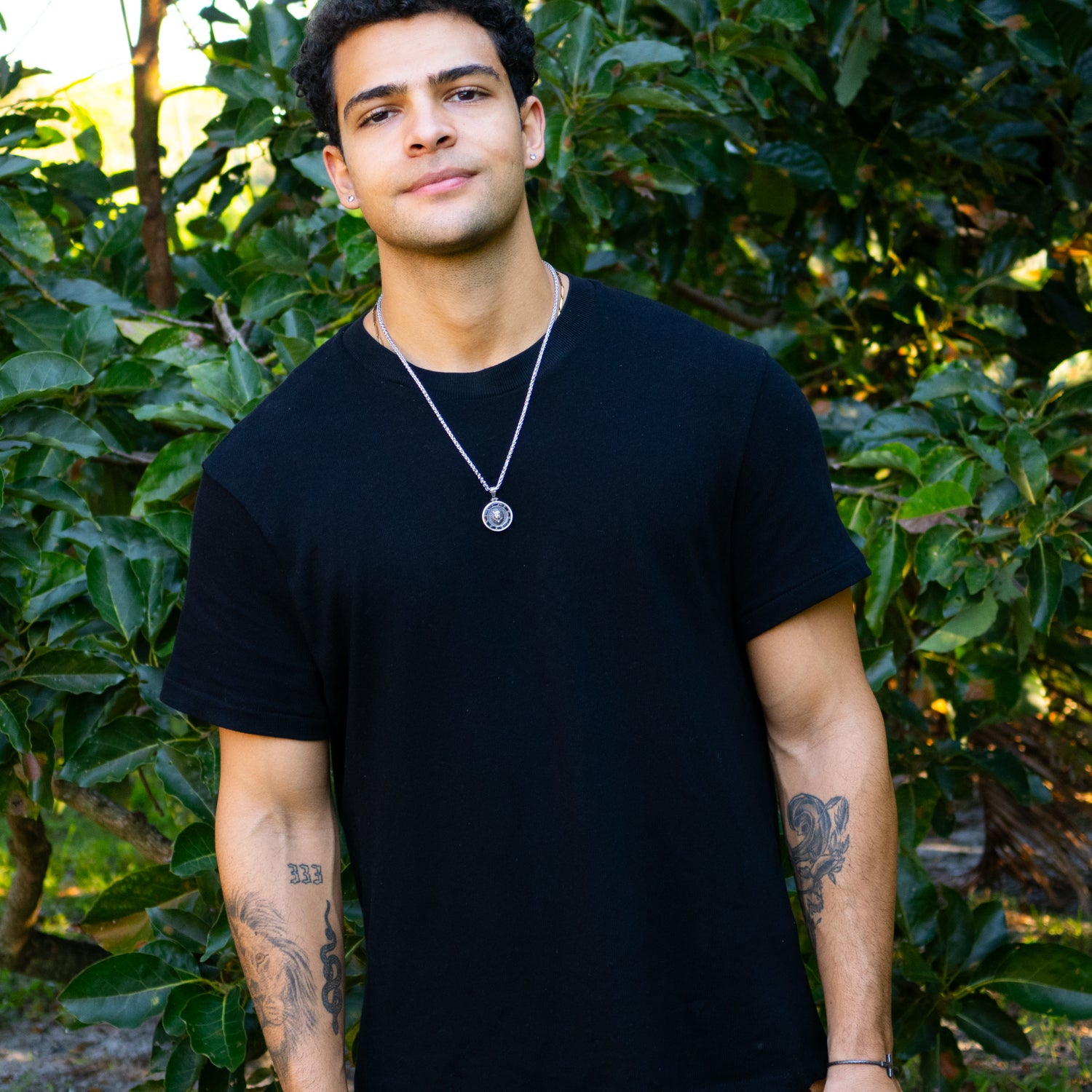 Sterling silver necklace with lion medallion pendant, pavé black CZ diamond eyes, rhodium finish, geometric features, masculine statement style.