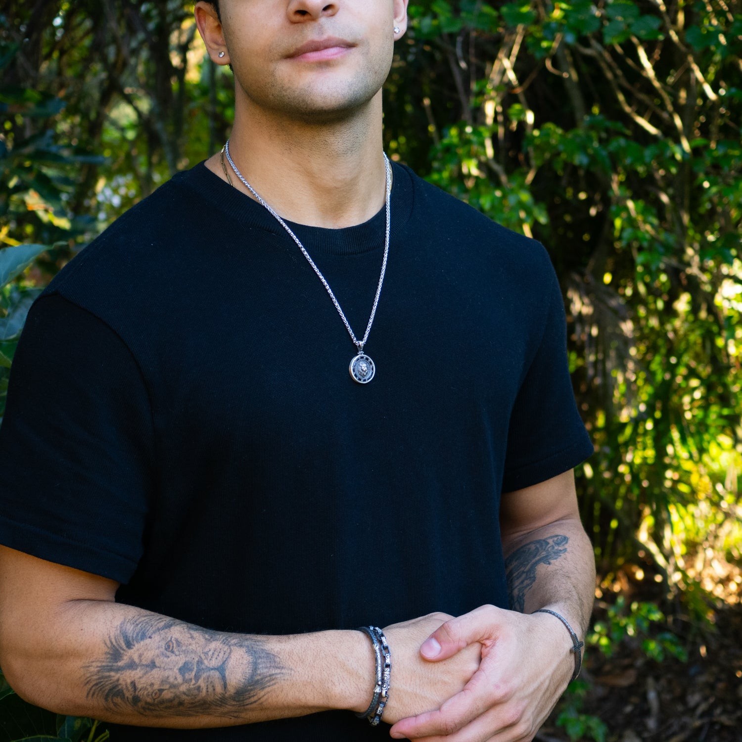 Sterling silver necklace with lion medallion pendant, pavé black CZ diamond eyes, rhodium finish, geometric details, bold masculine style.