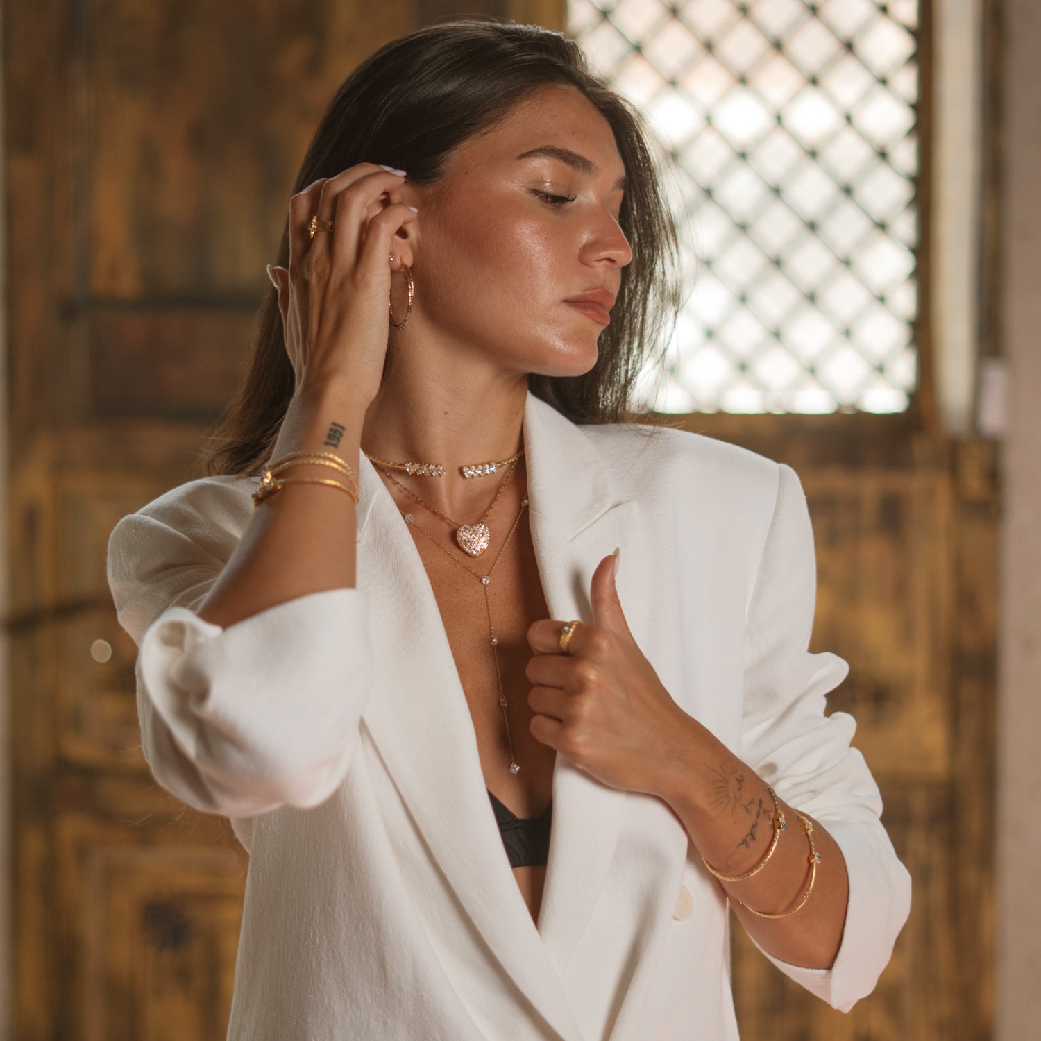 Woman in daylight wearing a marquise gold vermeil collar necklace with an open front