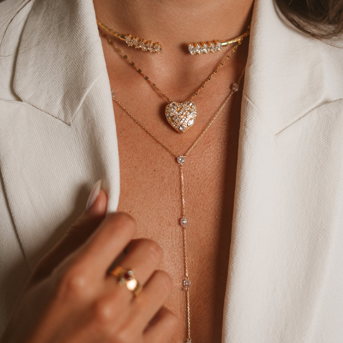 Gold vermeil marquise choker worn high at the throat above a layered heart pendant necklace