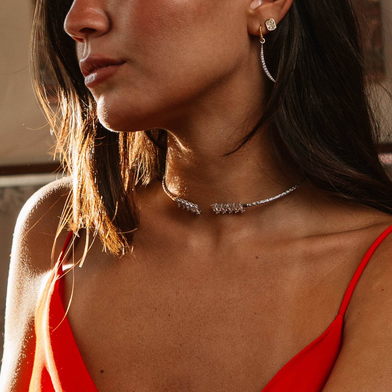 Woman in a red slip dress wearing a woven sterling silver marquise choker at the throat