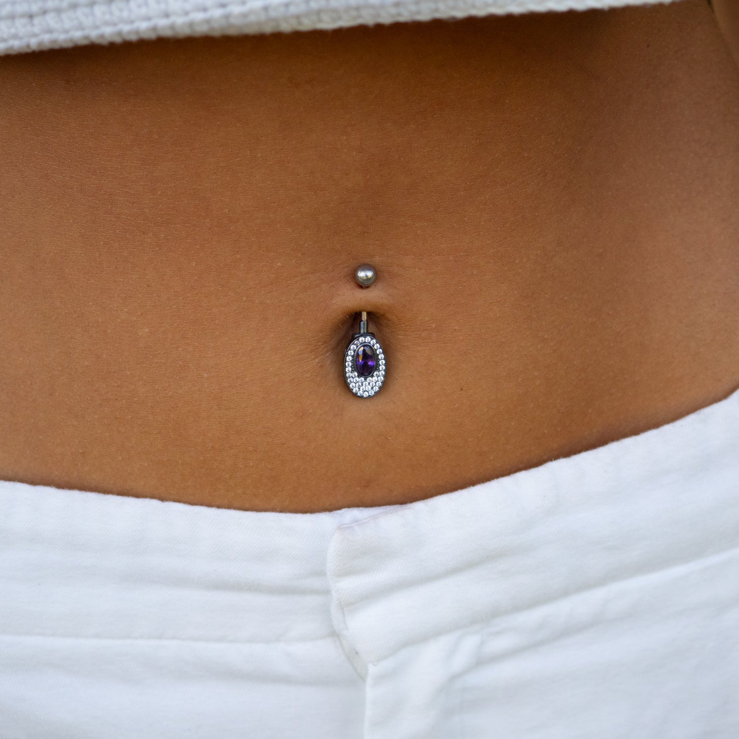 Sterling silver belly piercing with oval mystic amethyst center, CZ diamond accent, rhodium-plated finish, vibrant purple, elegant style.