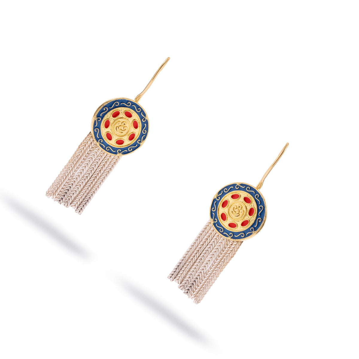 Angled studio view of the Mystic Bloom enamel medallion earrings with gold ear wires and long silver tassels