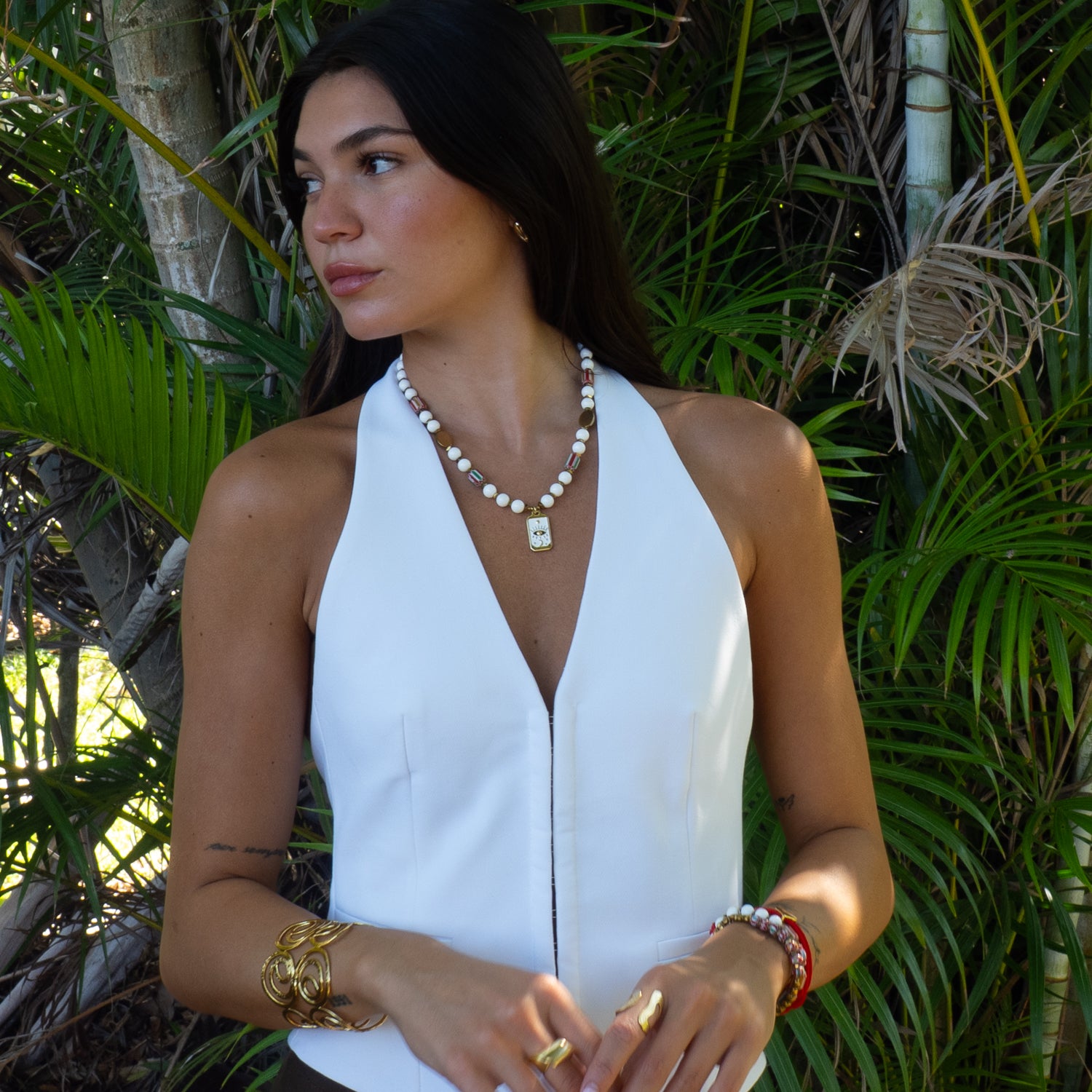 Model wearing handmade white jade evil eye tarot choker necklace outdoors