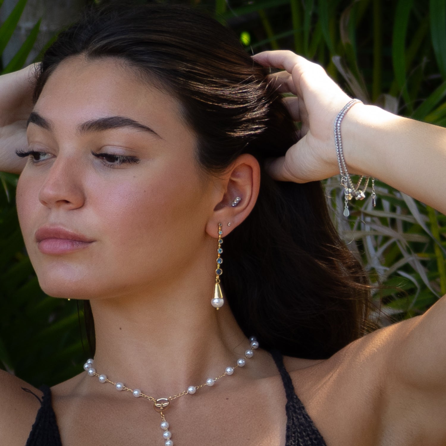 Handmade earrings featuring blue topaz gemstones and luminous freshwater pearl drops

