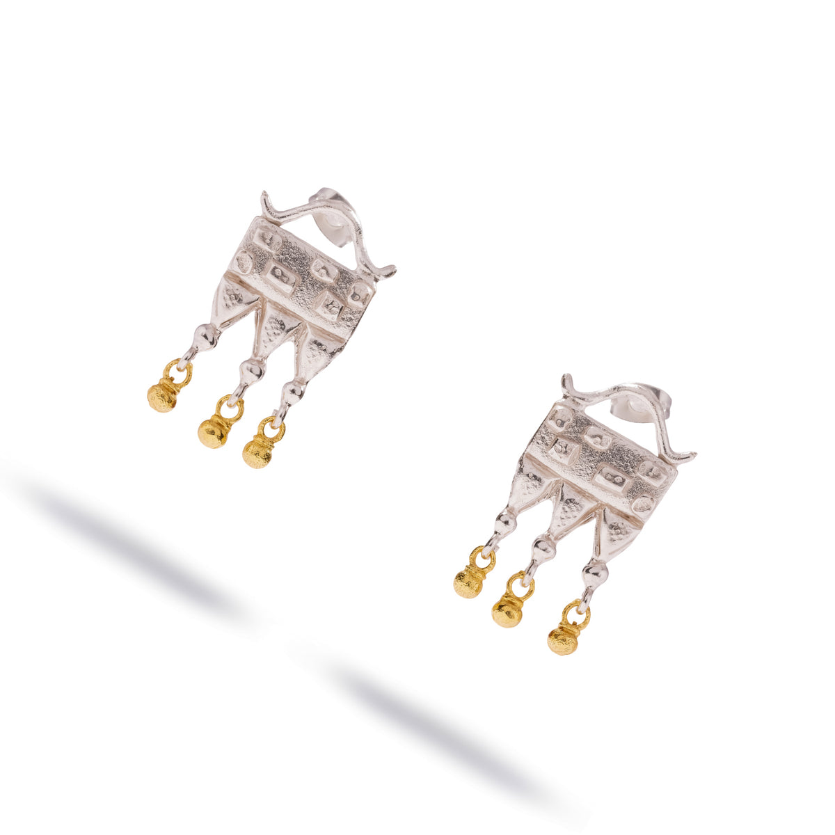 Pair of Mystic Temple Two Tone Silver Statement Earrings at an angle, showing the stamped squares and circles