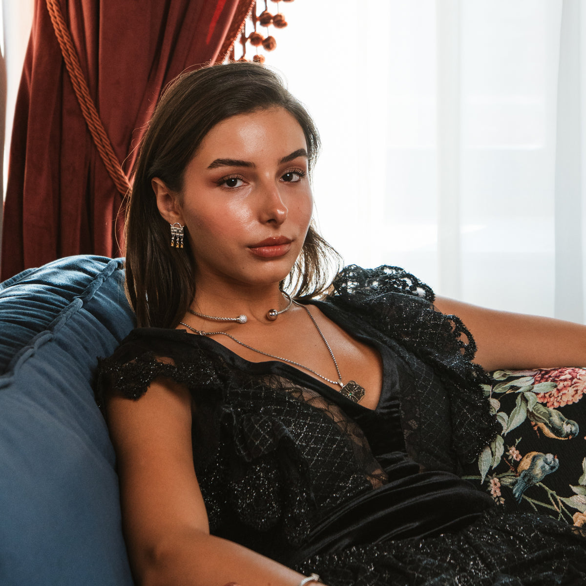 Portrait of the model wearing the Mystic Temple Two Tone Silver Statement Earrings with a silver choker