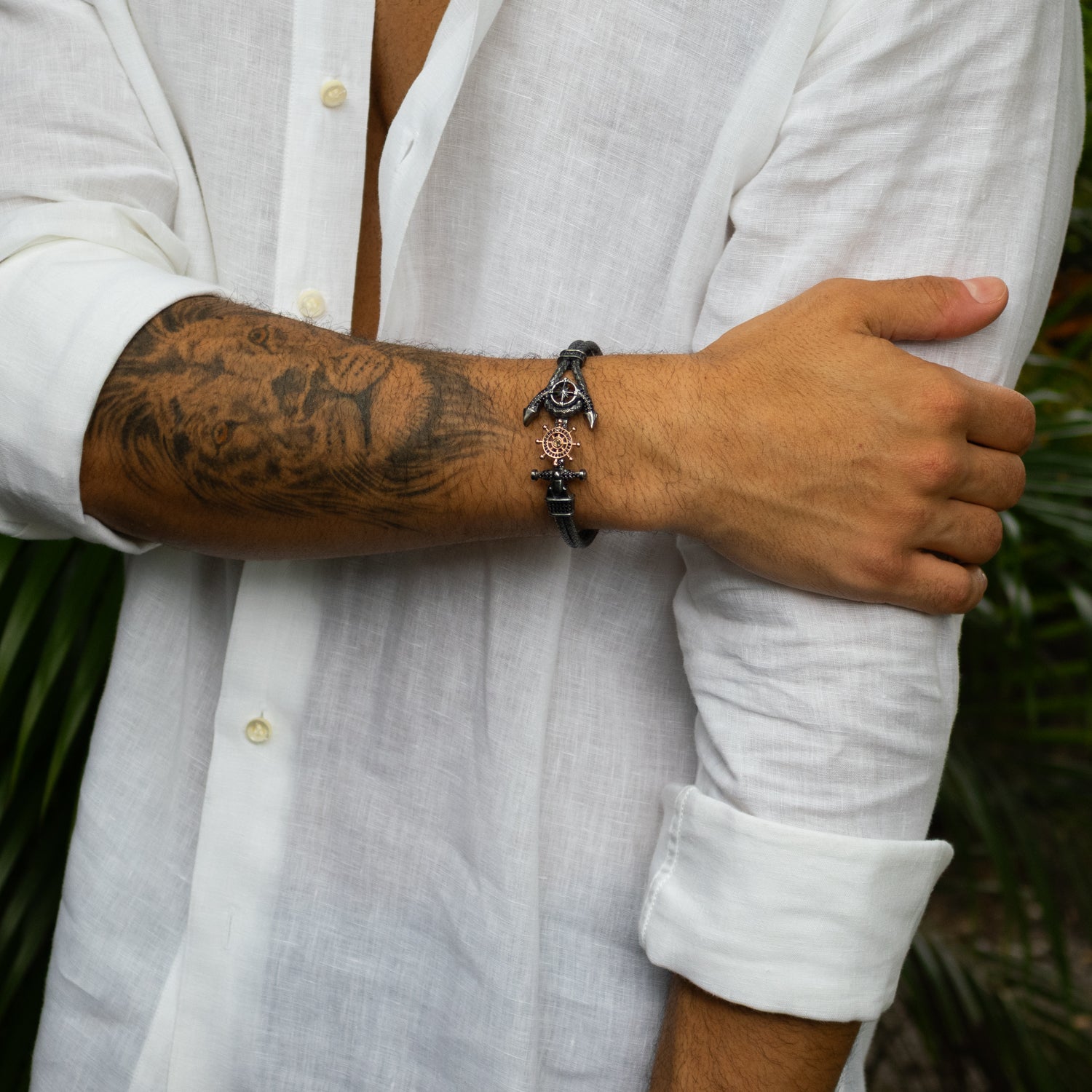 Sterling silver and rose gold bracelet with anchor and ship wheel motifs, black diamond details, woven design, nautical masculine style.