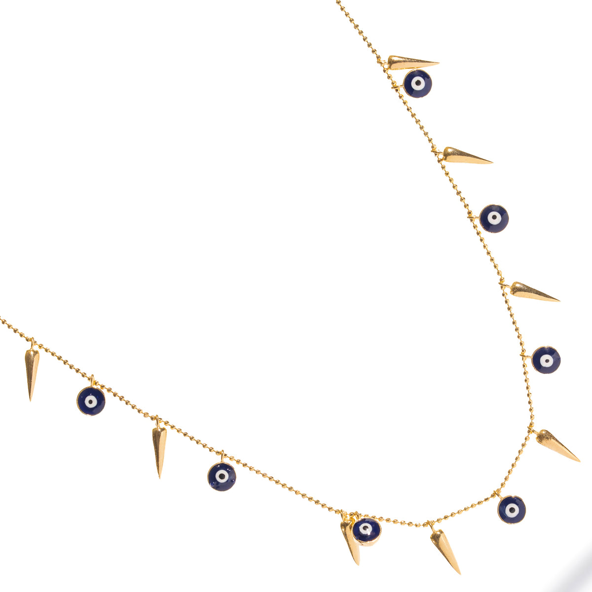 Navy enamel evil eye charms with white centers between slender gold spikes, angled view on white