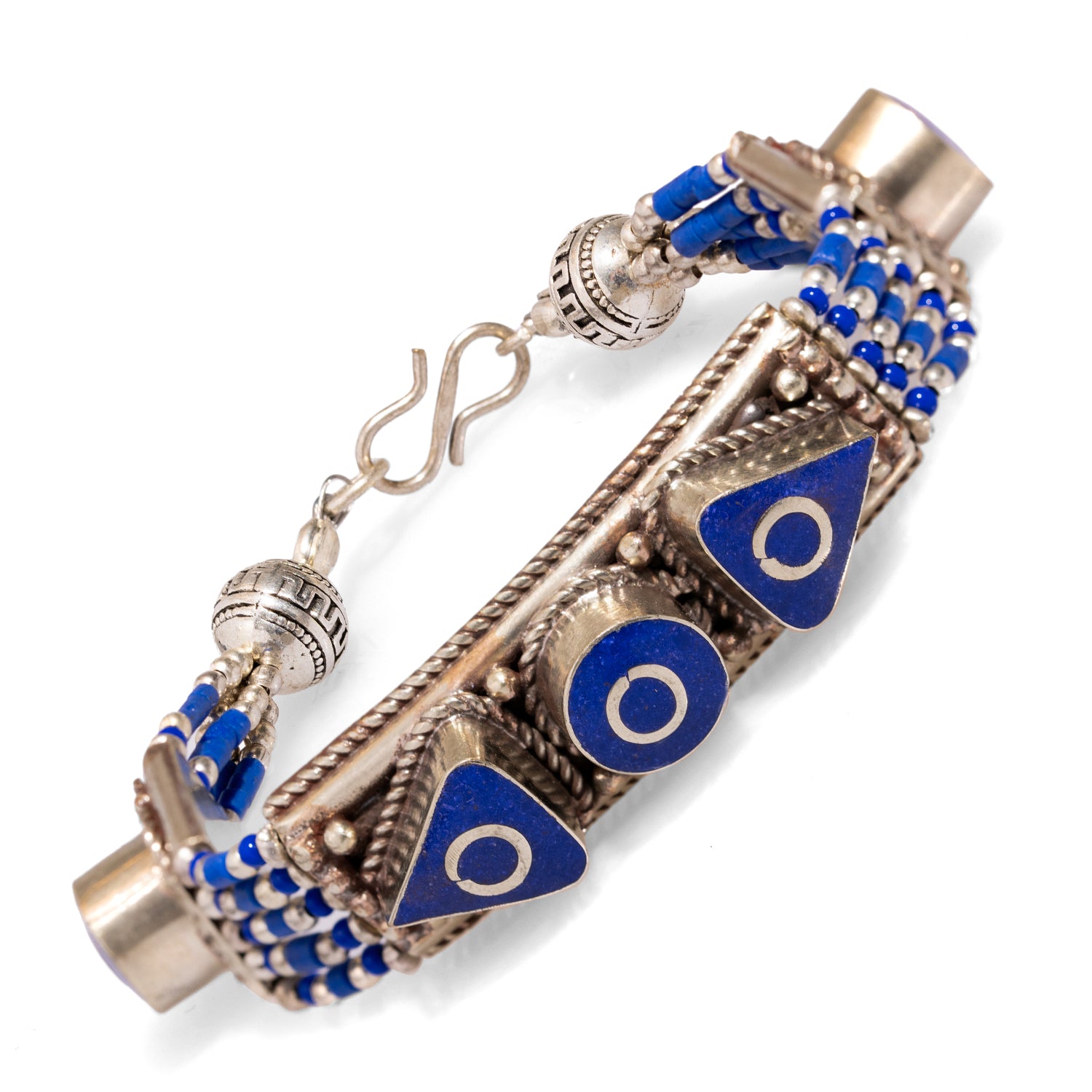 Artistic bohemian bracelet made from Nepalese silver, adorned with lapis lazuli stones and geometric carvings.
