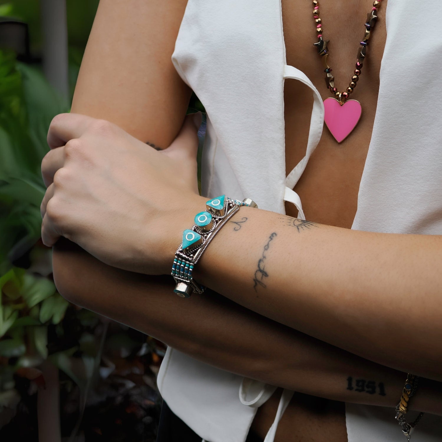 Handcrafted Nepalese silver bracelet featuring bold turquoise stones and bohemian-inspired designs.
