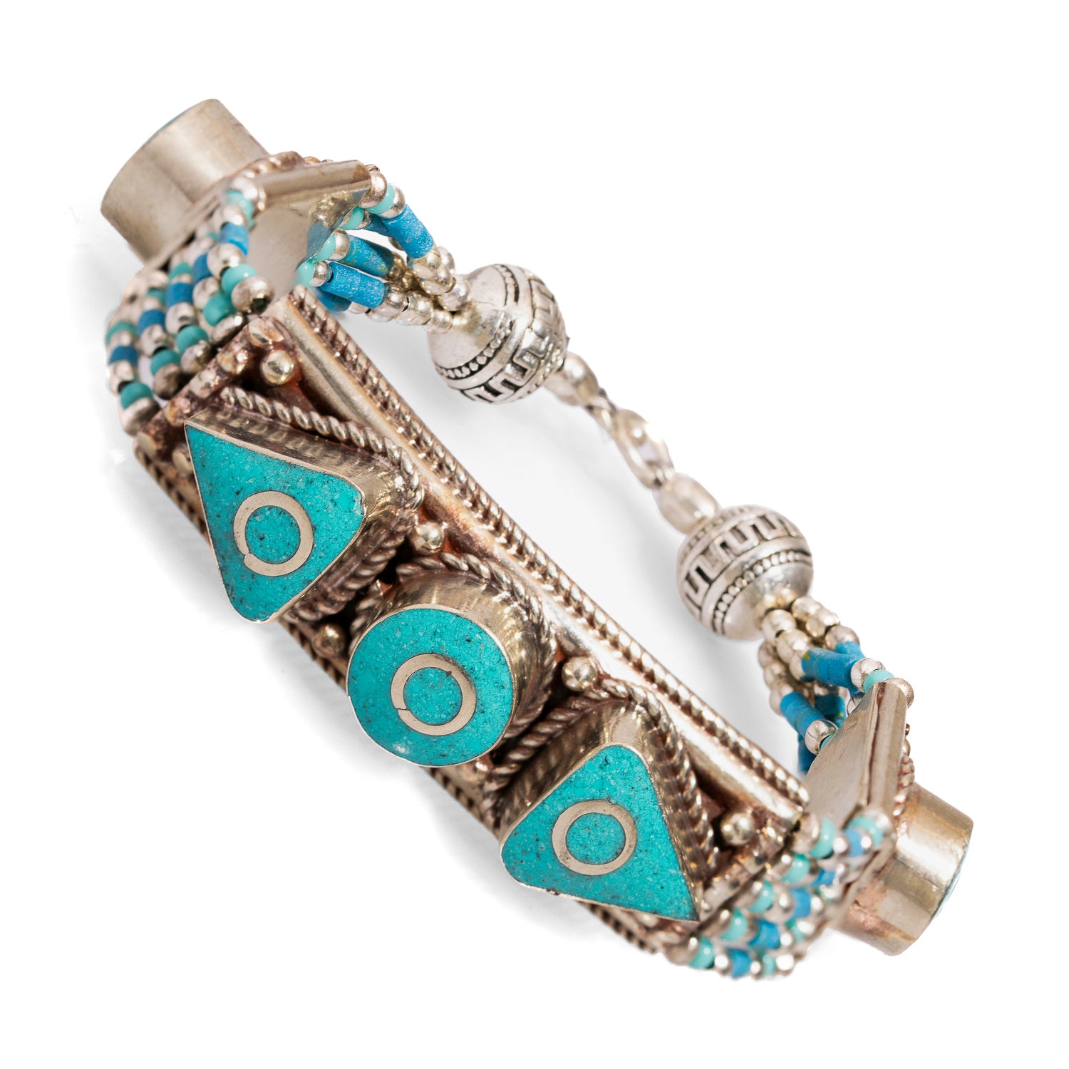 Chunky silver bracelet with detailed Nepalese patterns and striking turquoise accents for a bold look.
