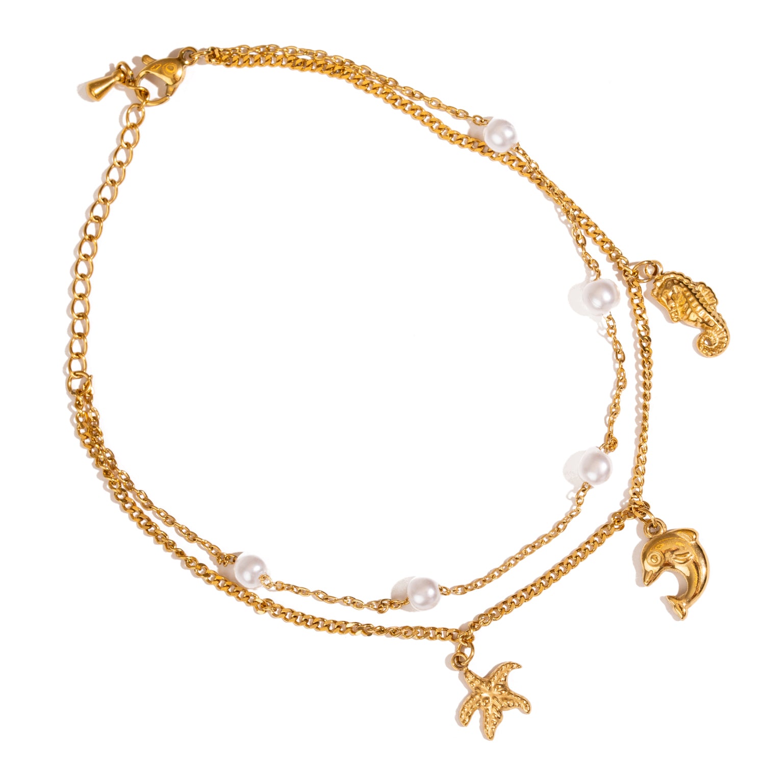 Layered gold anklet featuring starfish, dolphin, and seahorse symbols