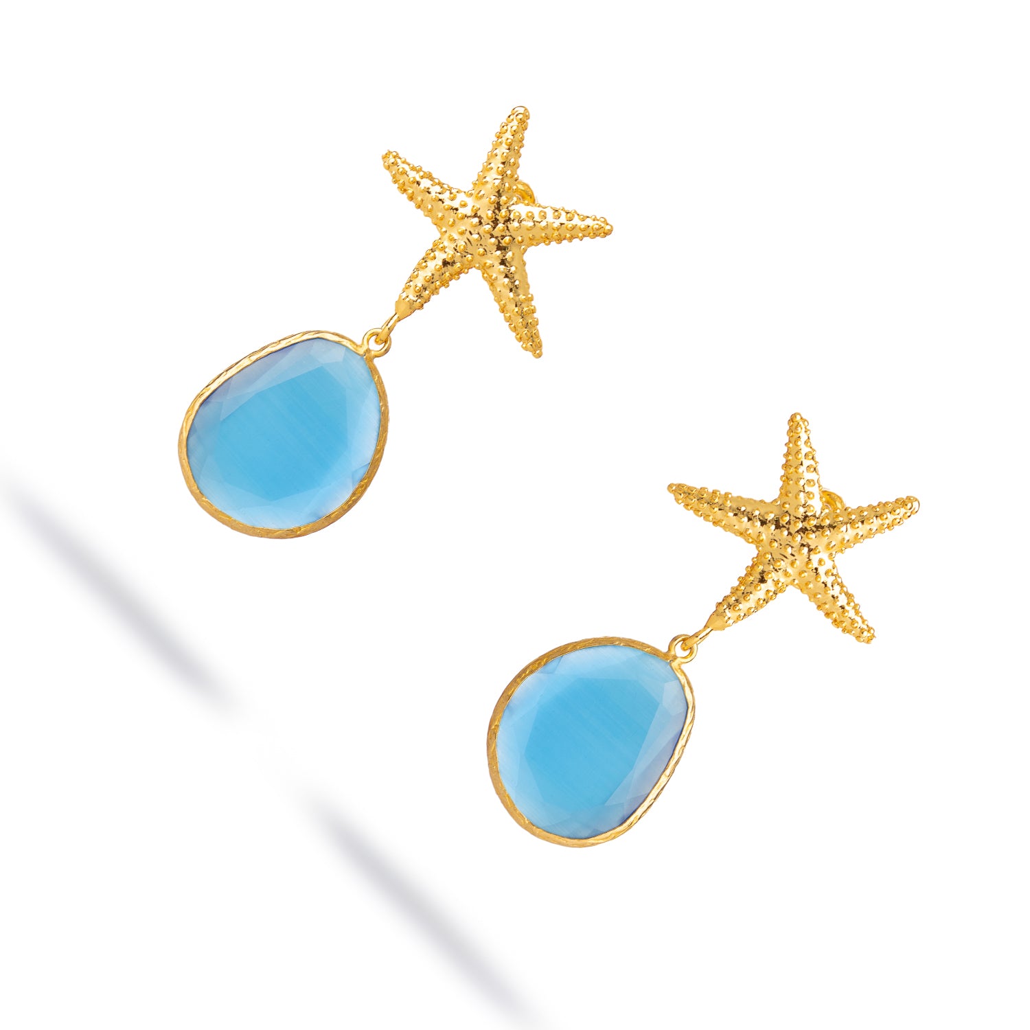 Starfish motif gold earrings featuring blue cat eye stone