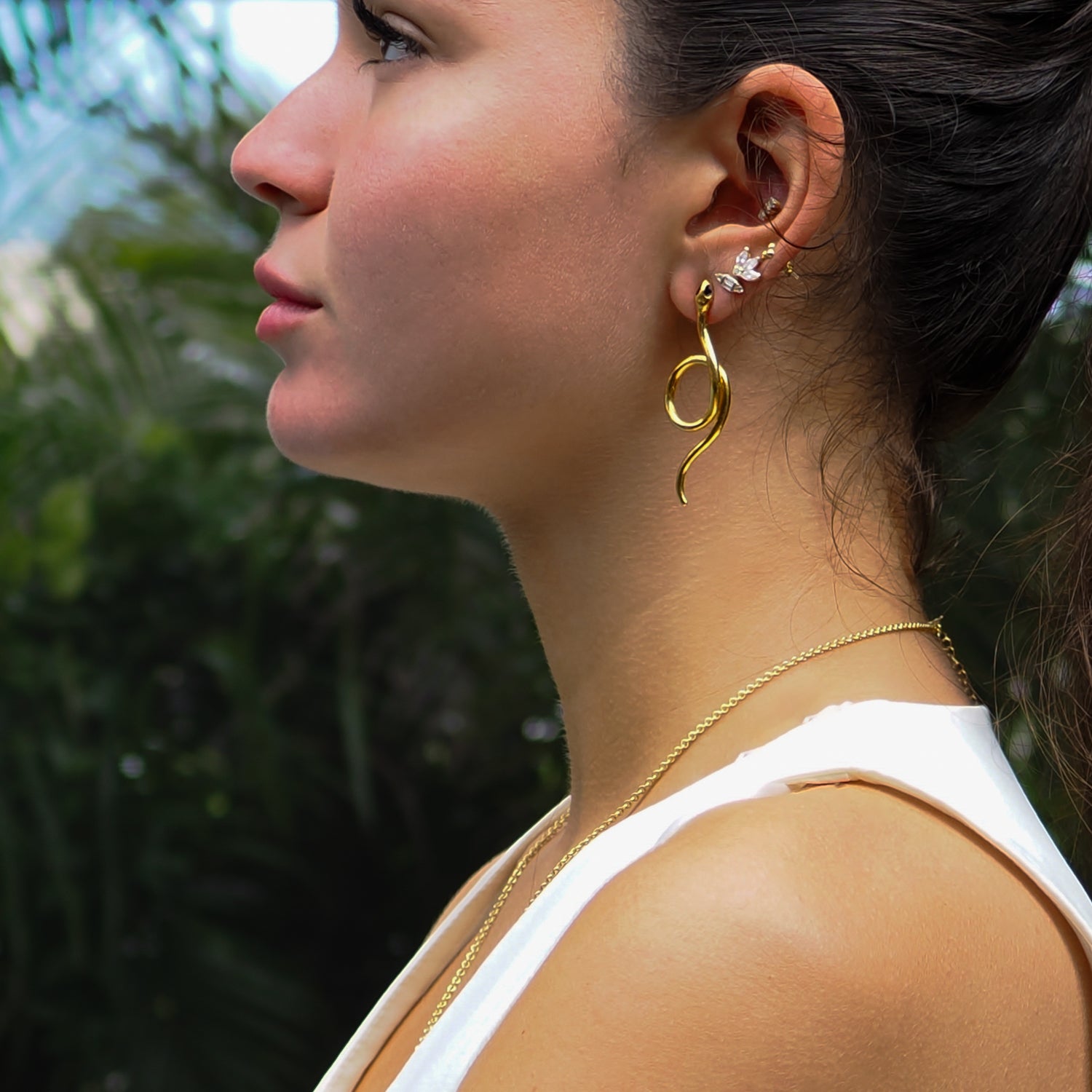 Statement serpent earrings with onyx accents, crafted in brass and plated in 24K gold.
