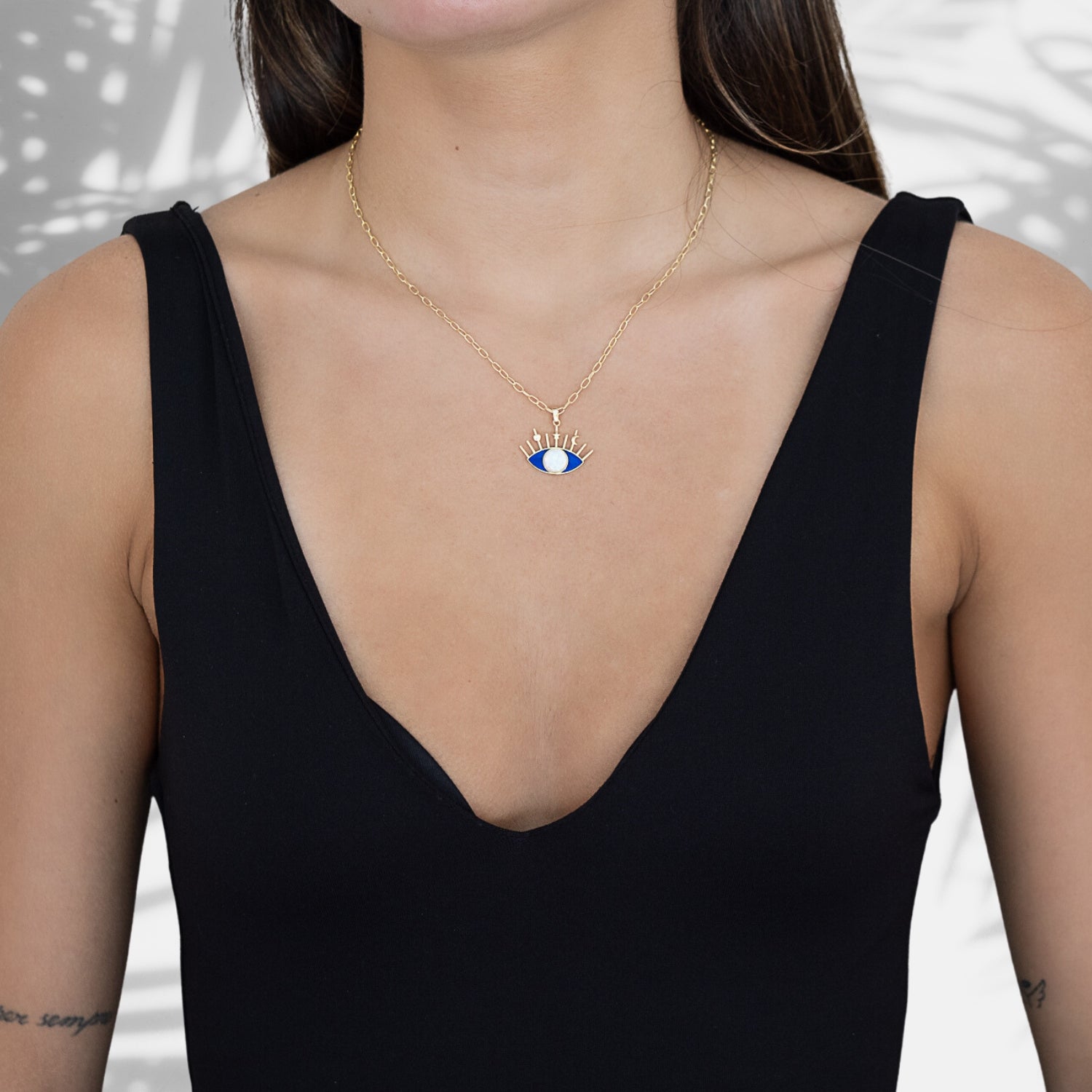 A model wearing the Opal Blue Evil Eye Necklace, radiating style and spiritual energy.