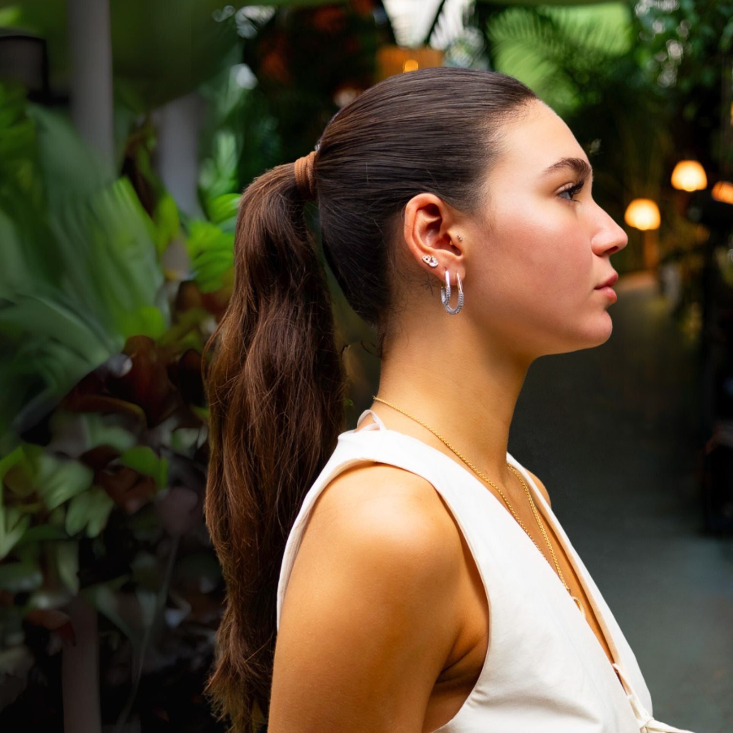 Timeless mini gold hoop earrings adorned with pave CZ diamonds for a touch of understated elegance.
