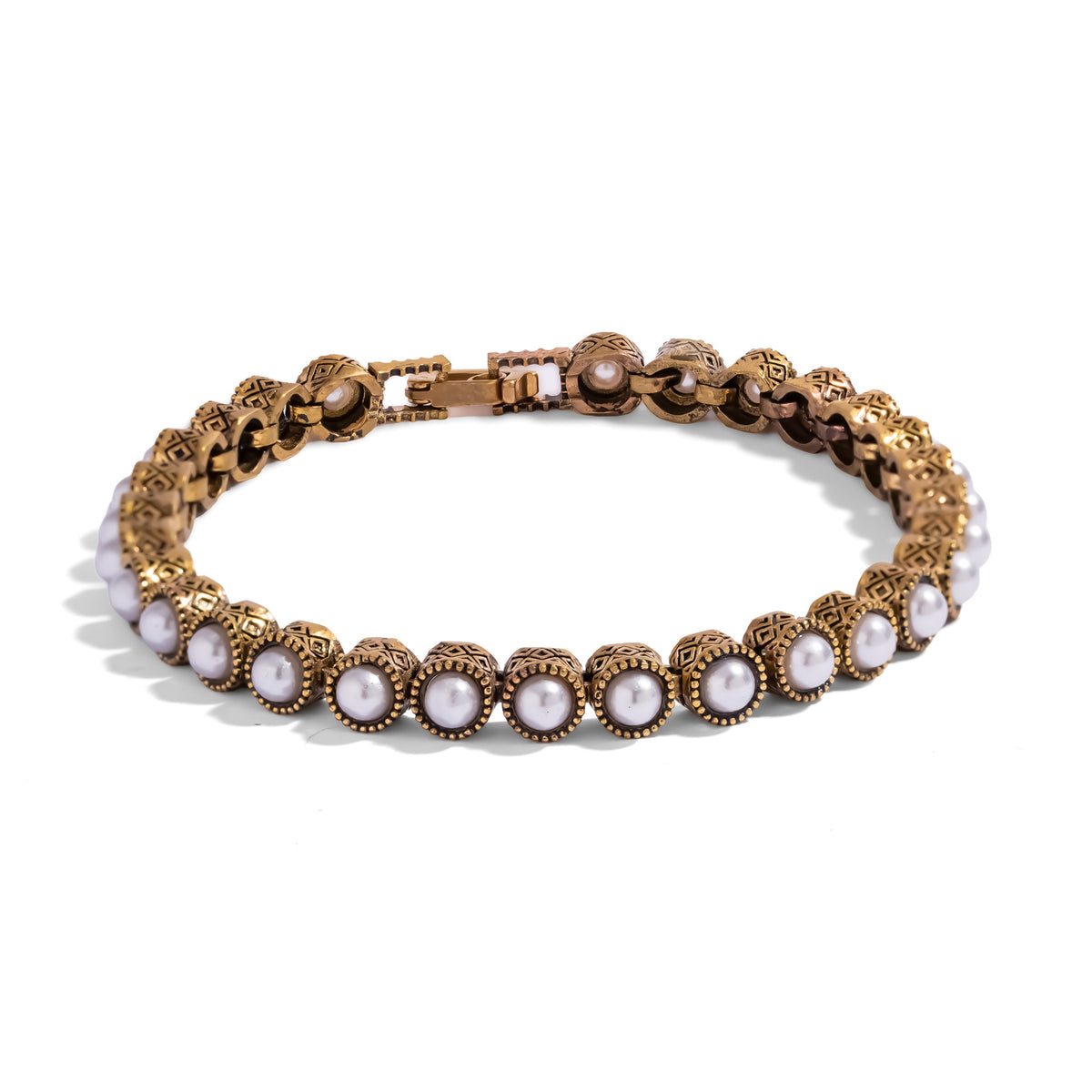 Pearl Antique Gold Tennis Mystic Bracelet, a continuous line of pearls in antiqued gold bezels stamped with a repeating diamond motif