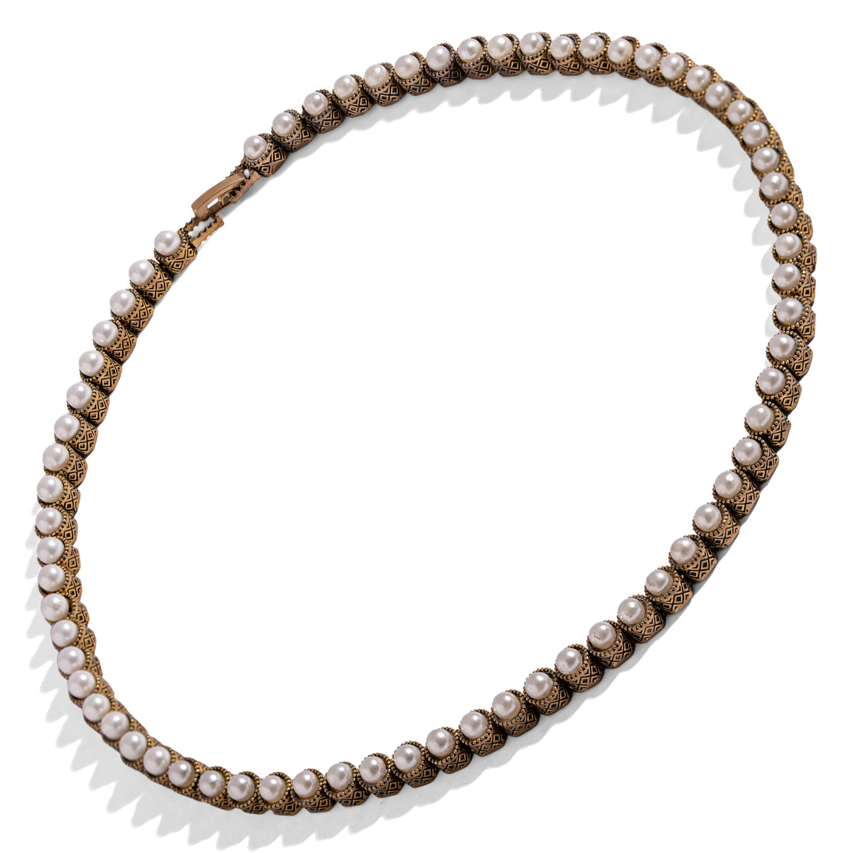 Antique gold pearl tennis necklace shown in full, each pearl seated in its own patterned bezel