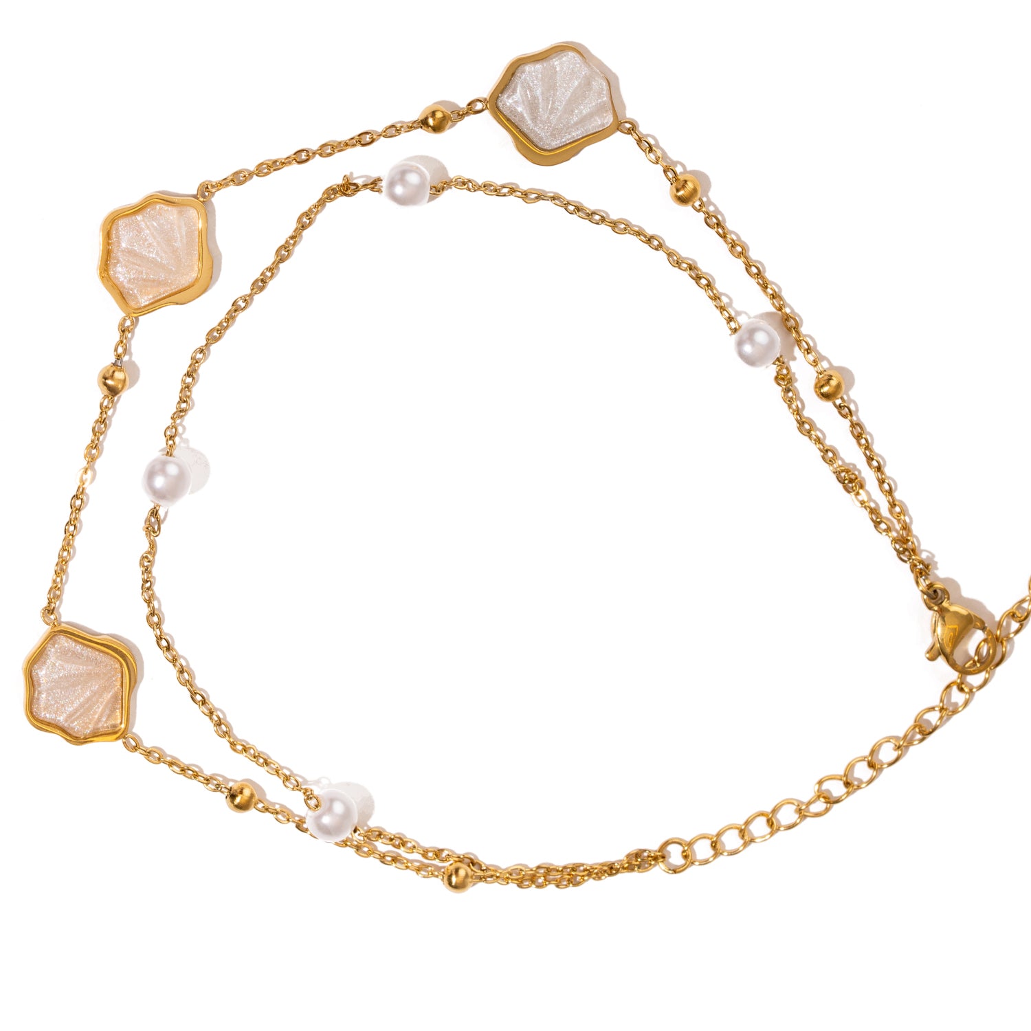 Layered gold anklet with marine charms and natural pearls