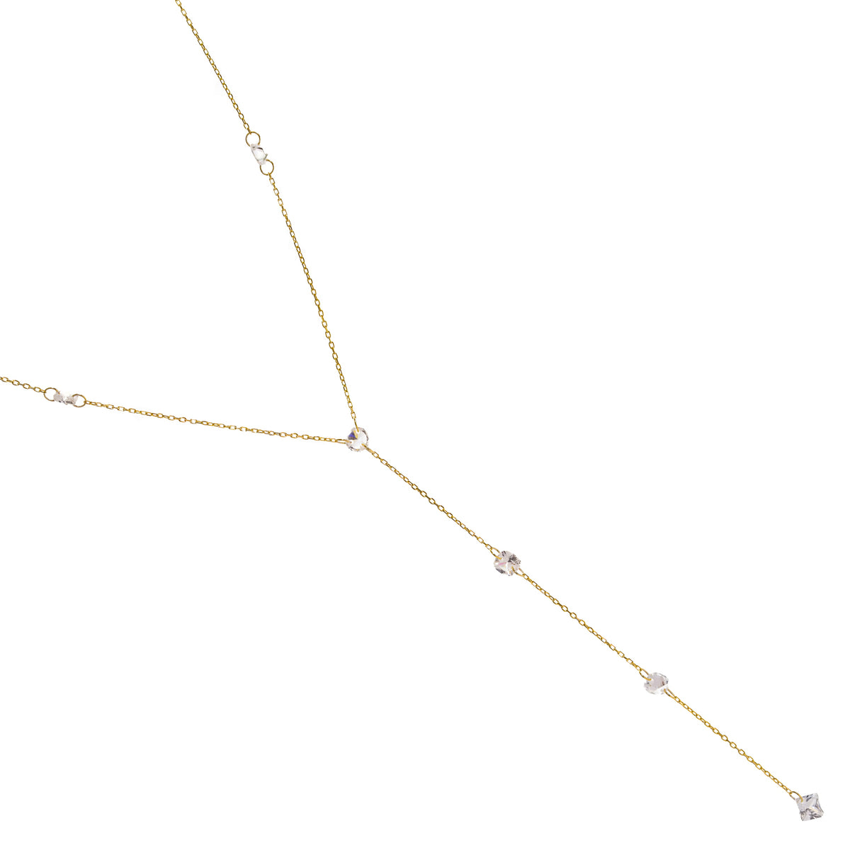 Princess cut zircon gold lariat necklace laid diagonally on white