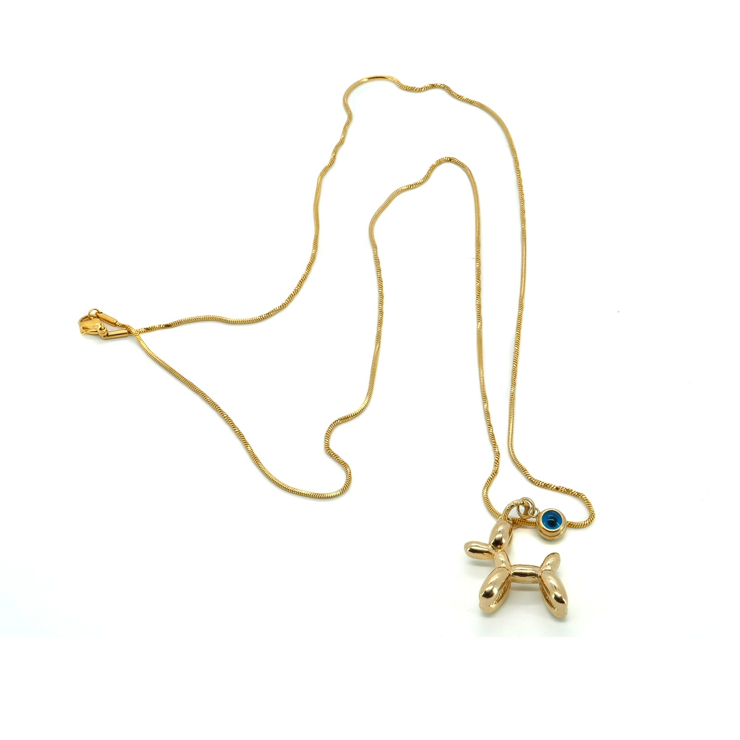 Close-up of playful balloon dog charm paired with gold-plated sterling silver evil eye


