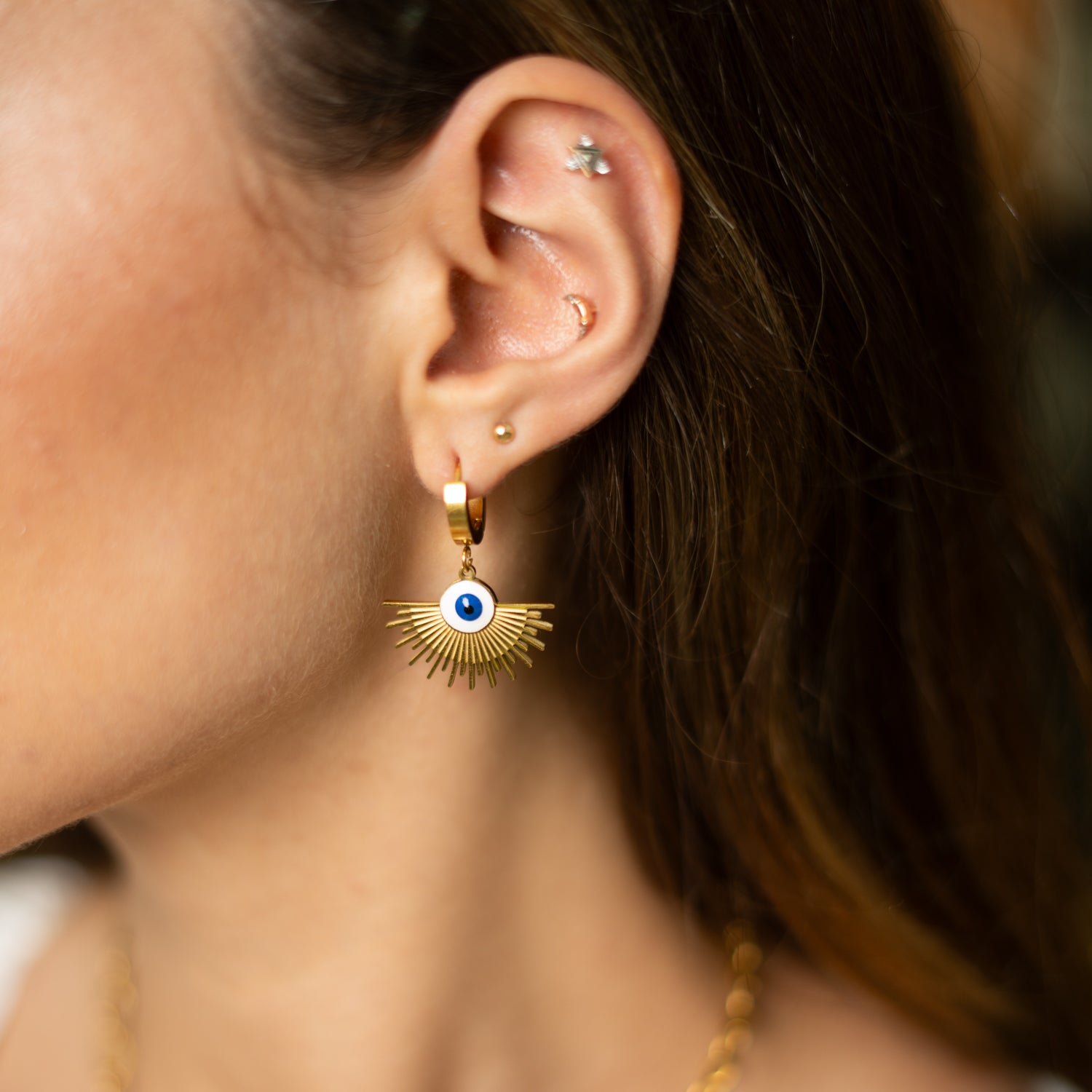 Bold gold-plated evil eye earrings with golden ray design