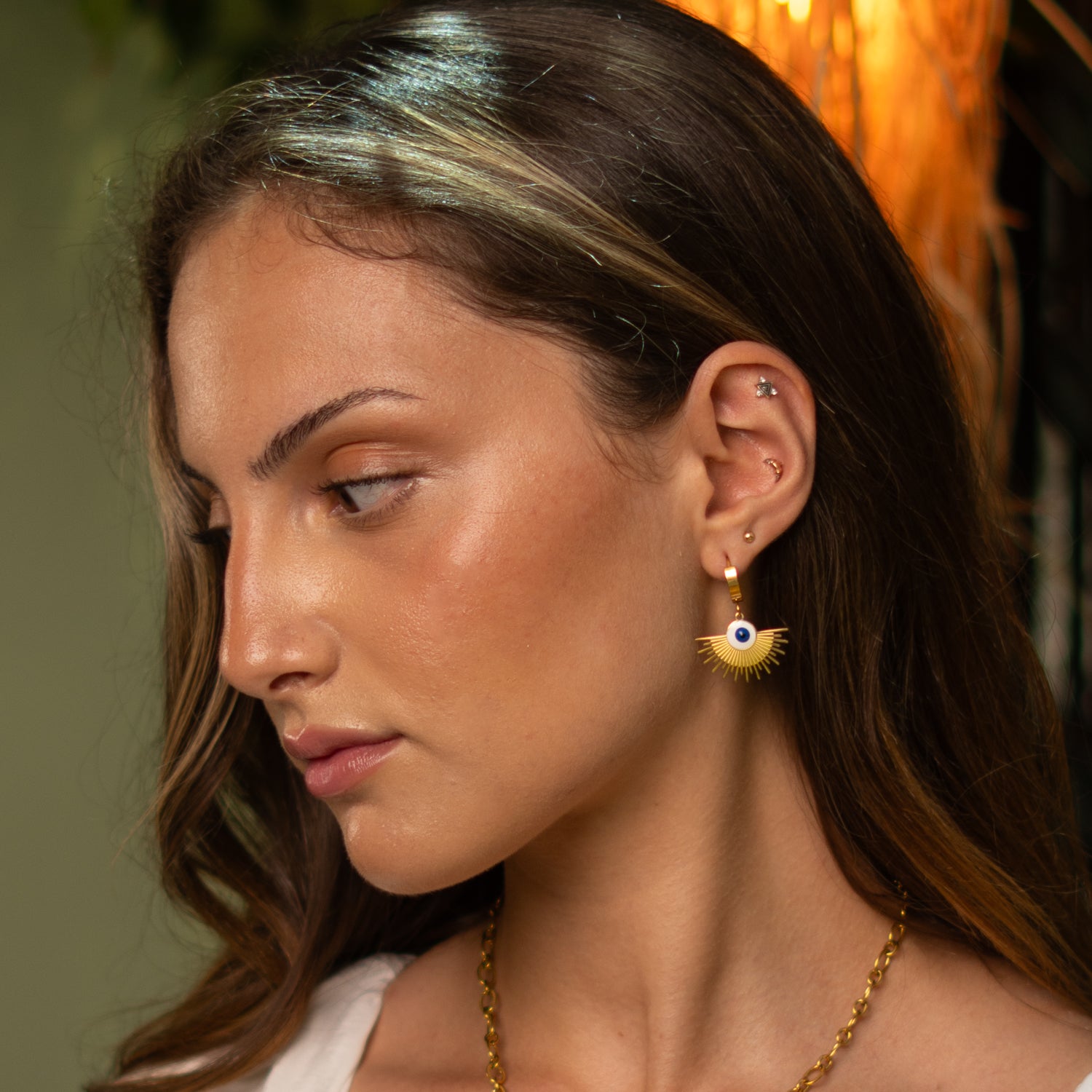 Modern evil eye hoop earrings in gold with symbolic protection