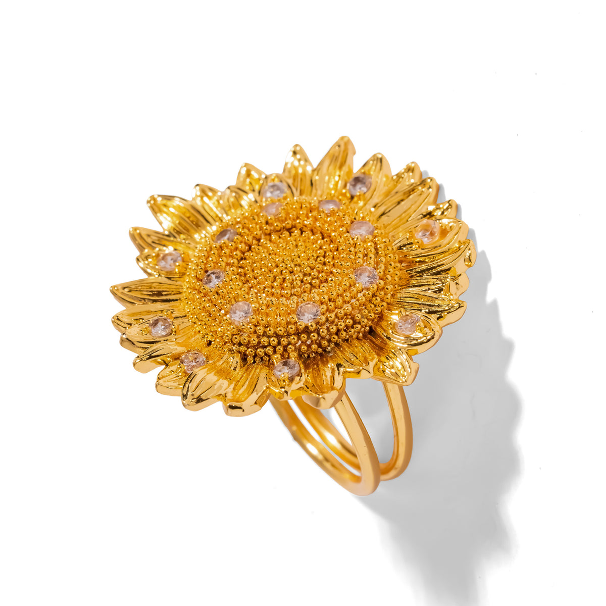 Top angled view of the gold sunflower ring showing radiating textured petals and sparkling cubic zirconia