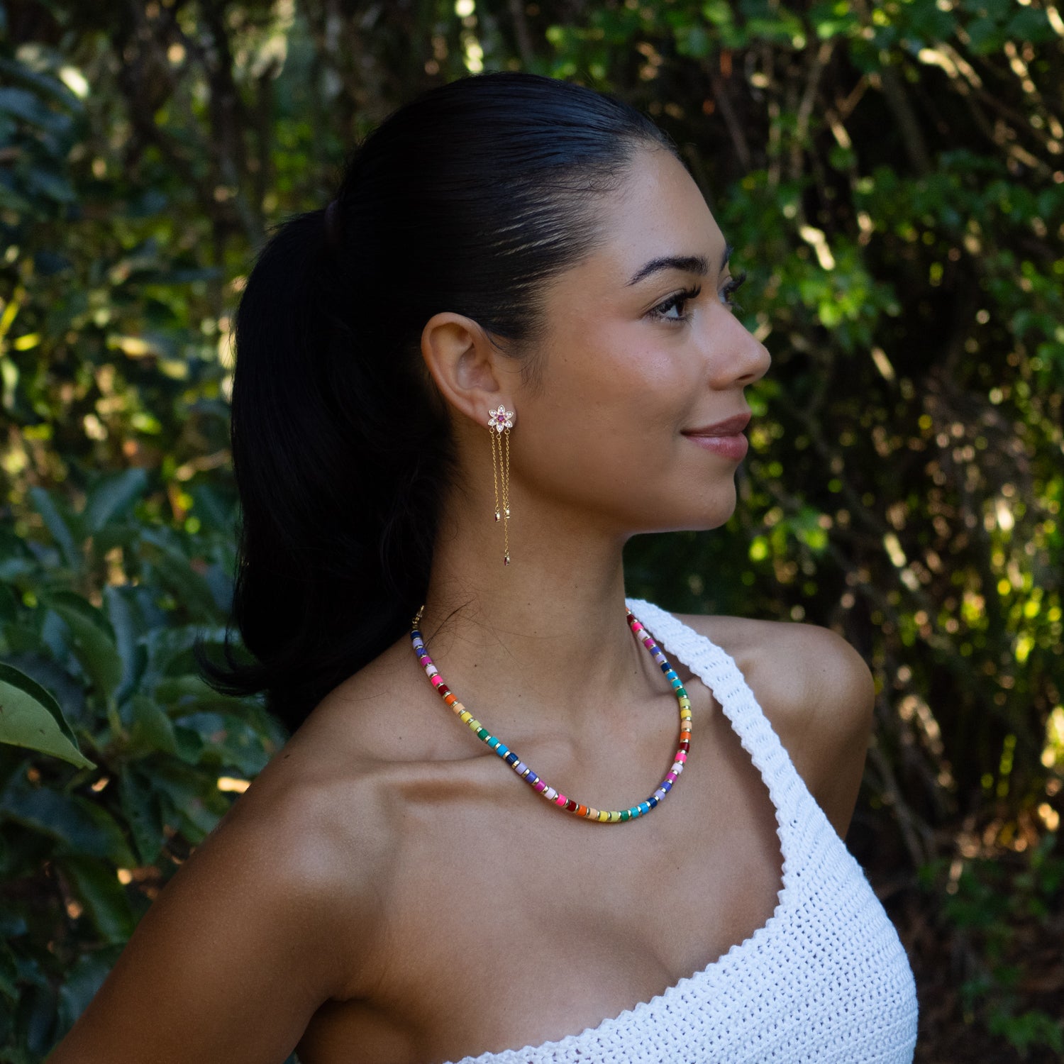 Model wearing handmade rainbow ceramic summer choker necklace outdoors