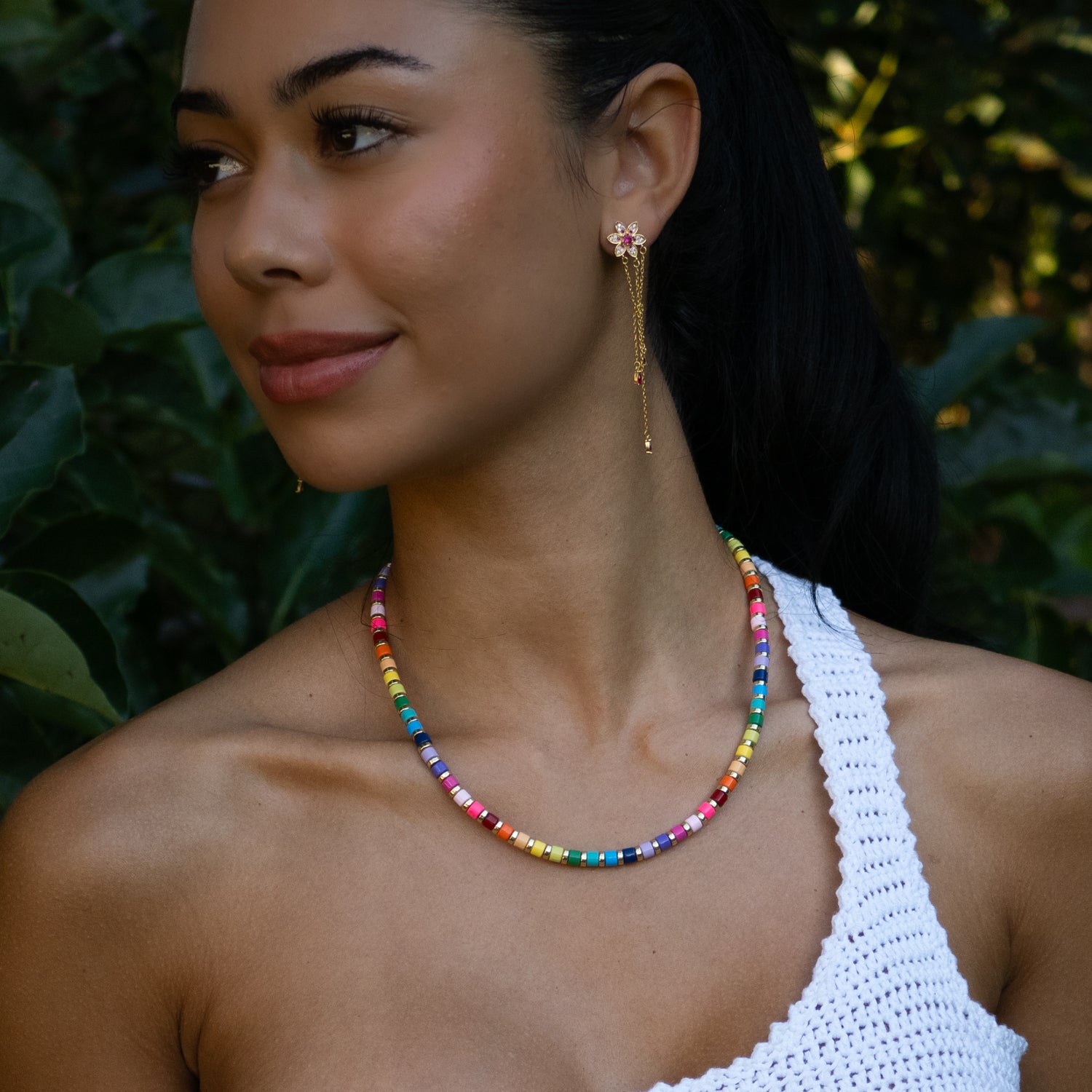 Woman wearing rainbow ceramic bead summer choker with white crochet top