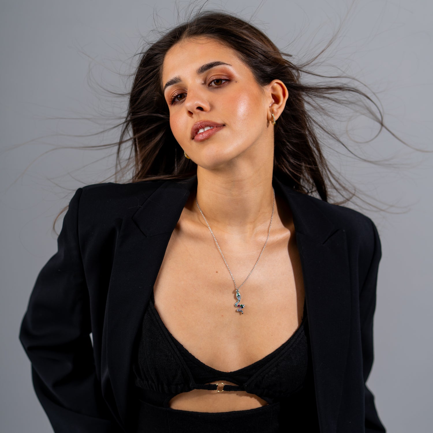 Rainbow Guardian spiral snake pendant necklace with colorful gemstones on a slim silver chain.

