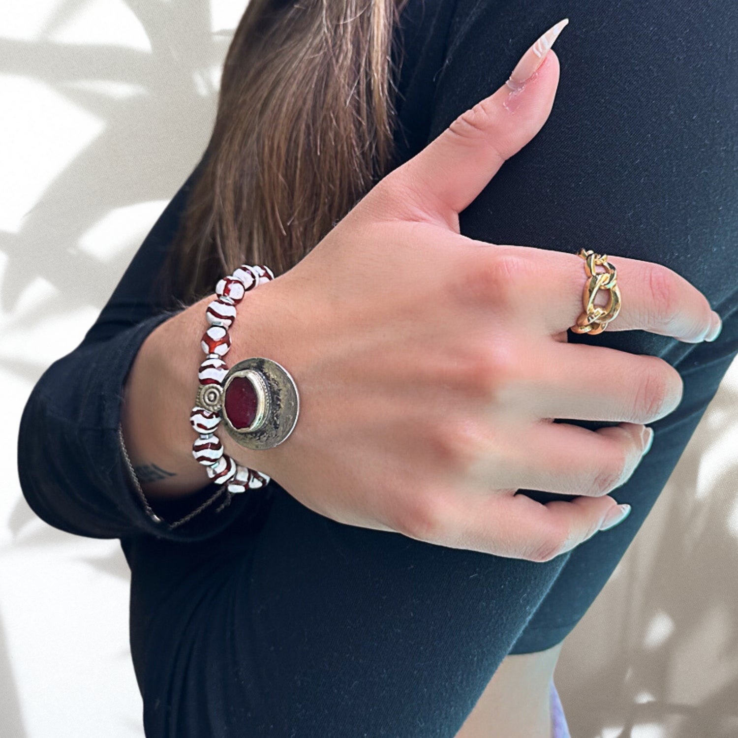 The hand model confidently wears the Royal Abundance Bracelet, symbolizing the enchanting beauty of handcrafted jewelry and personal style.