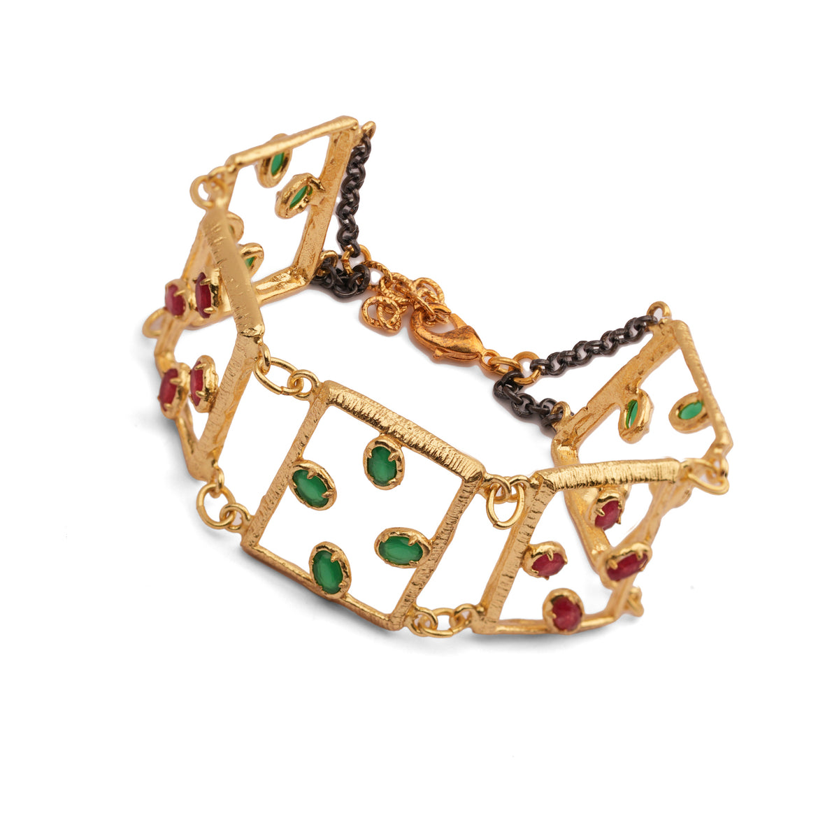 Angled studio view of the open square gold link bracelet showing claw set green and red oval gemstones and the dark chain clasp
