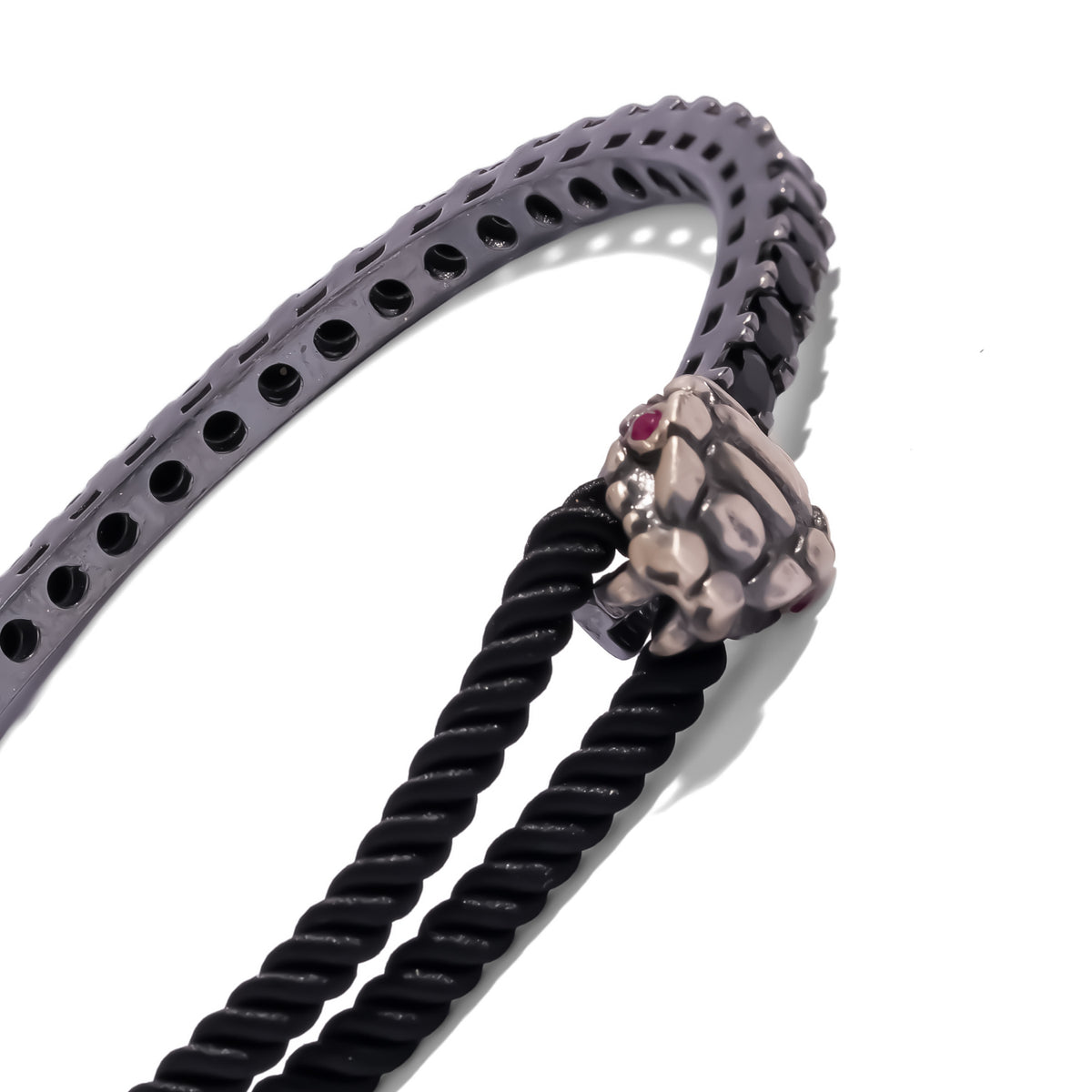 Close view of the sculpted snake head with ruby eyes and the black zircon set oxidized silver bar