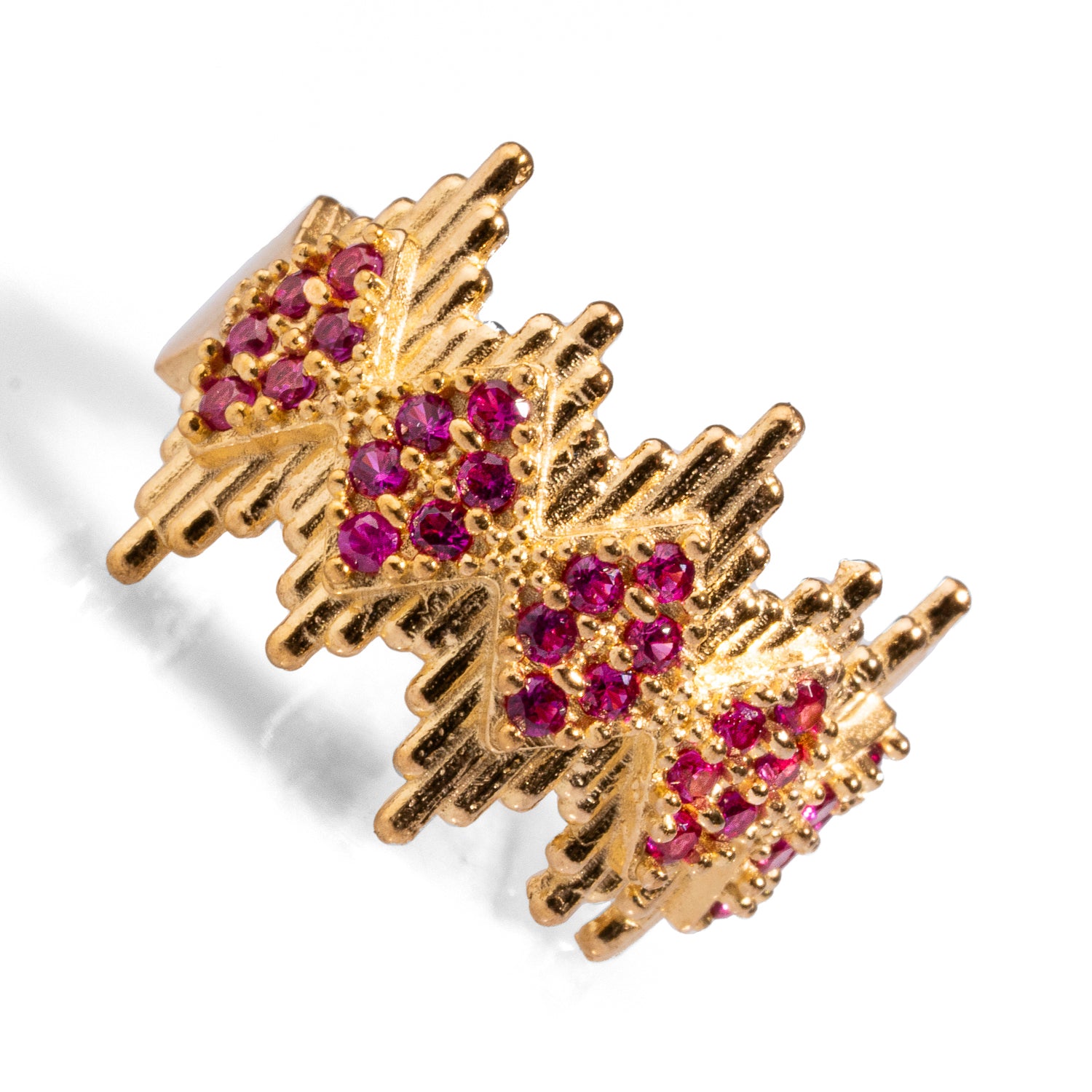 Bold 24k gold-plated statement ring with geometric crown lines and ruby stones, featuring an adjustable band for versatility and comfort.
