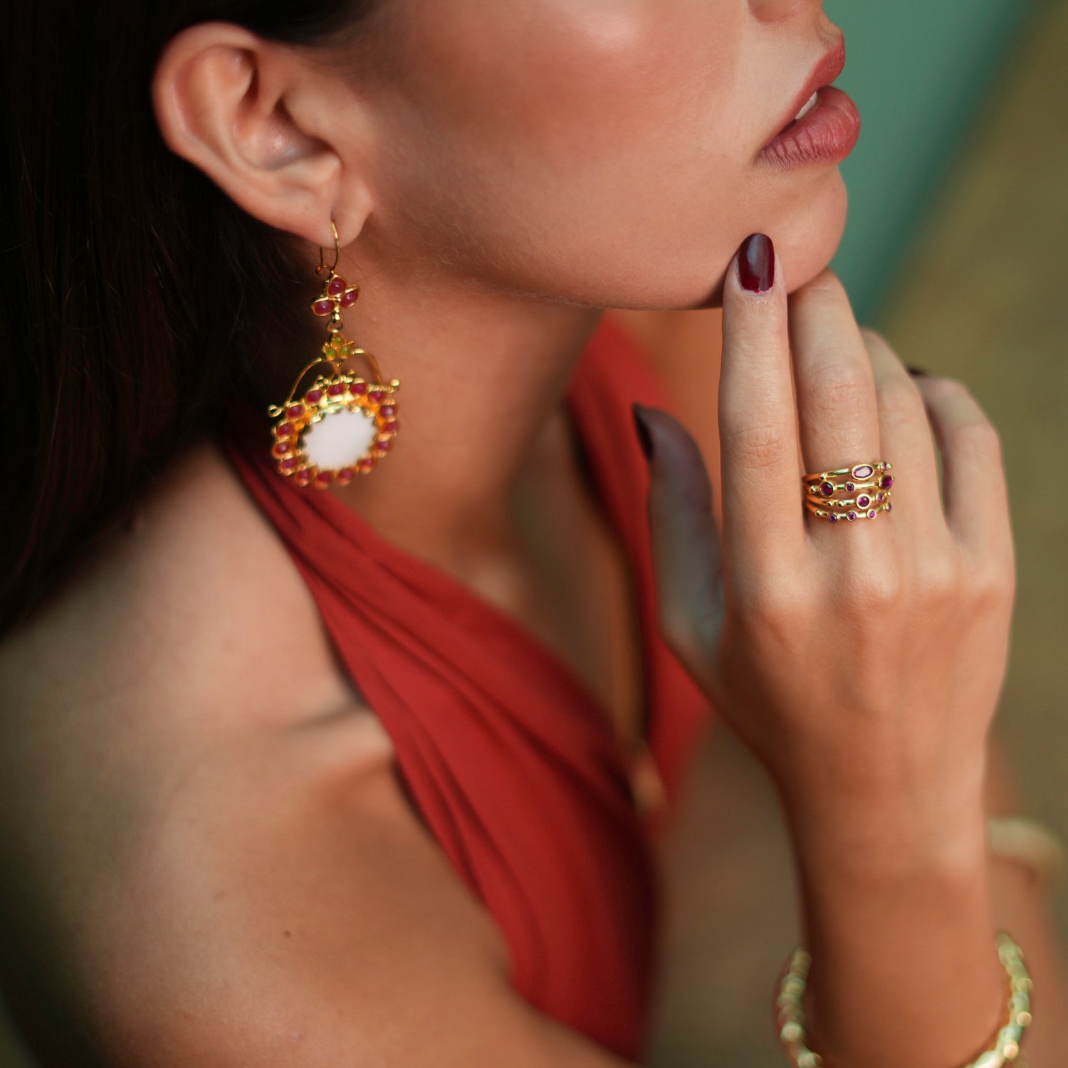 Stunning adjustable statement ring with varying sizes of ruby stones against a 24k gold-plated backdrop, offering a radiant and timeless elegance.
