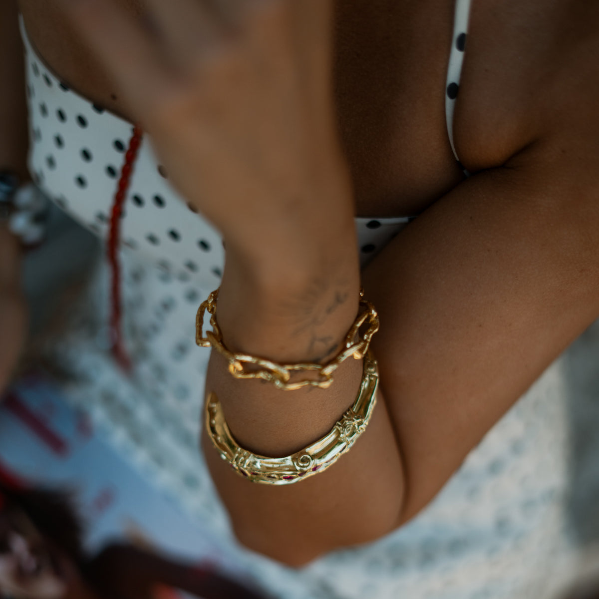 Overhead view of the Ruby Teardrop Antique Anatolian Symbols Gold Cuff Bracelet on the wrist, showing the antique gold surface