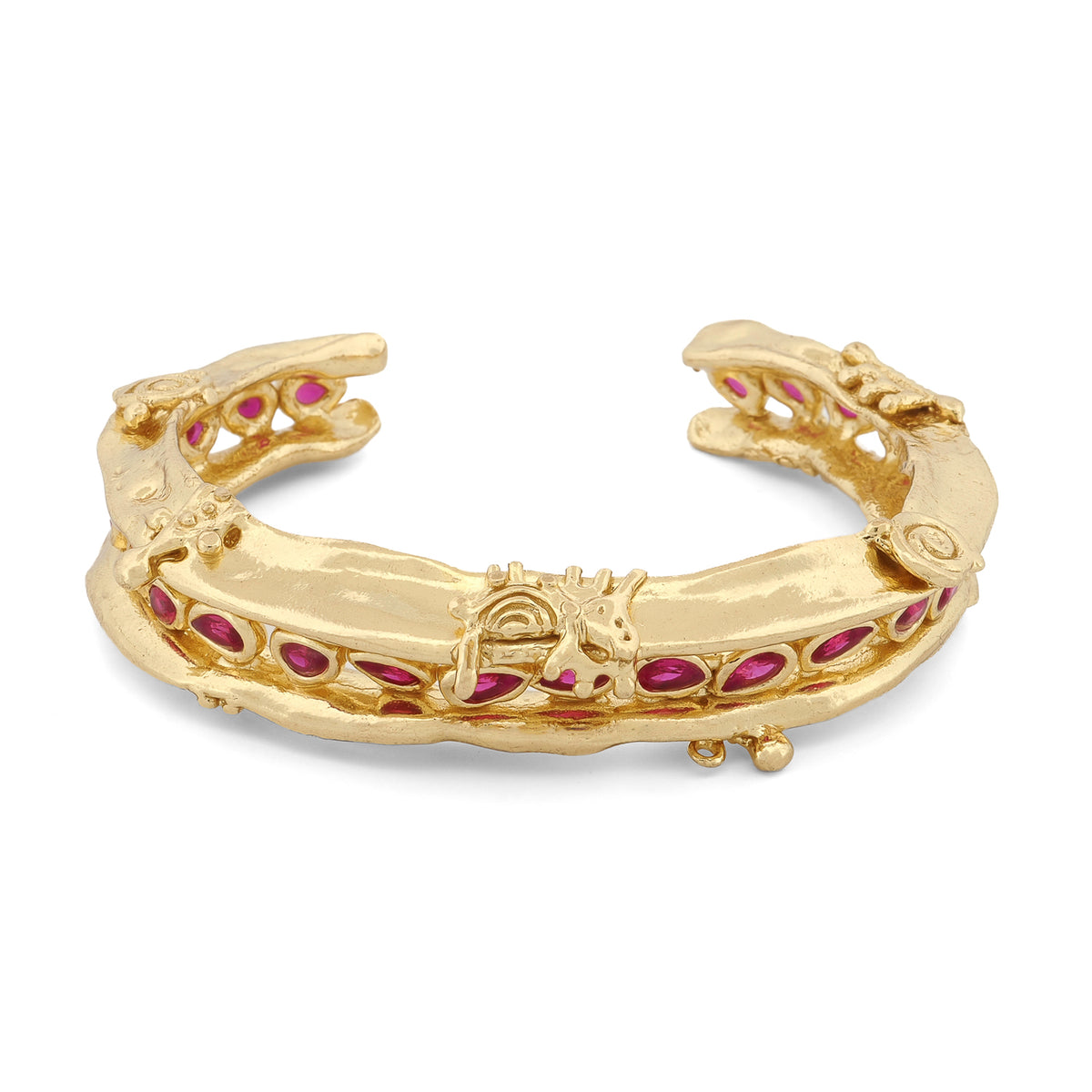 Angled view of the Ruby Teardrop Antique Anatolian Symbols Gold Cuff Bracelet showing the raised scrollwork and embossed symbols