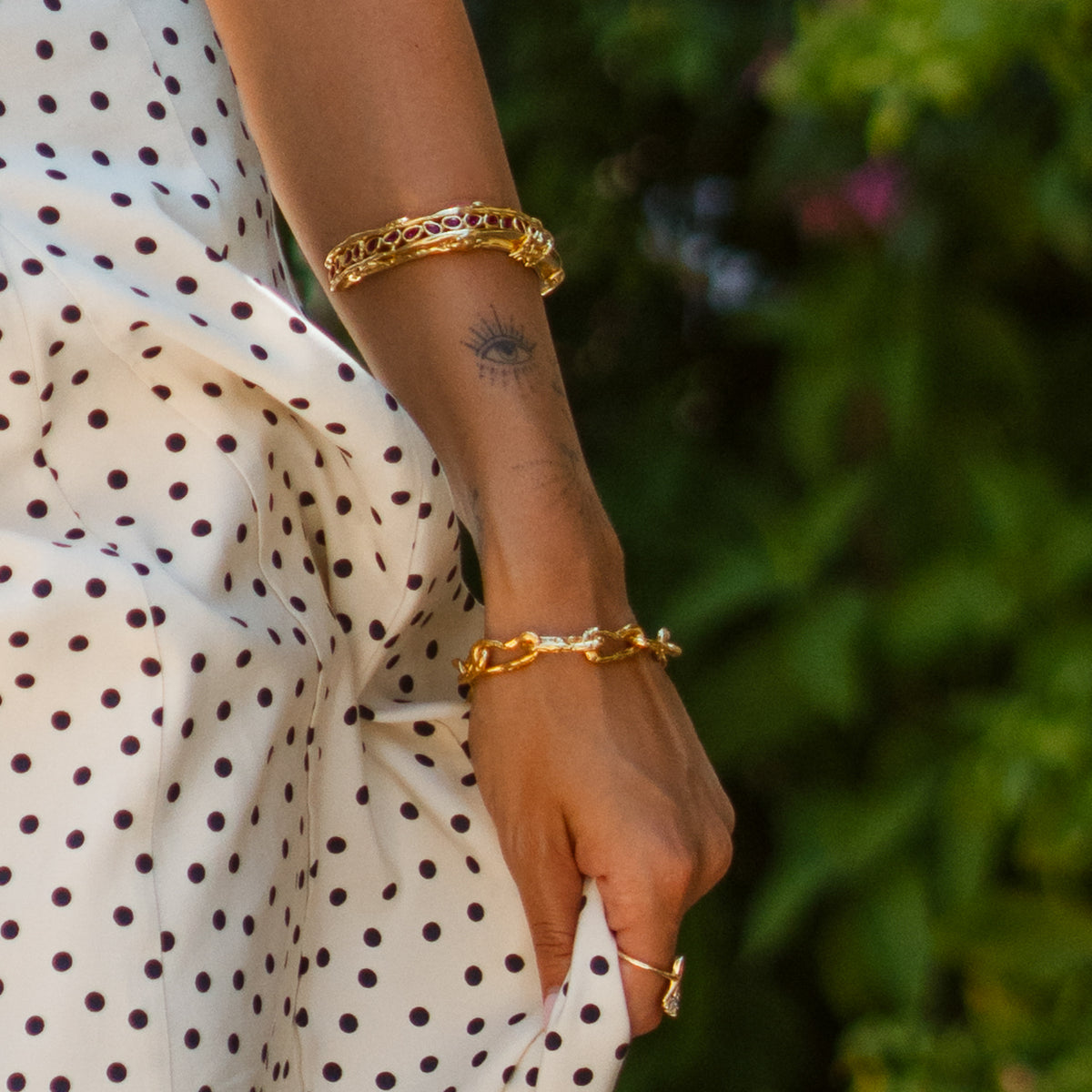Ruby Teardrop Antique Anatolian Symbols Gold Cuff Bracelet worn high on the arm with a gold chain bracelet below