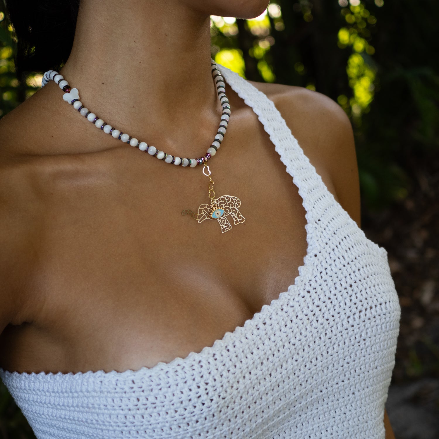 Pearl necklace with colorful hematite beads and gold-plated elephant evil eye charm for protection and luck.​