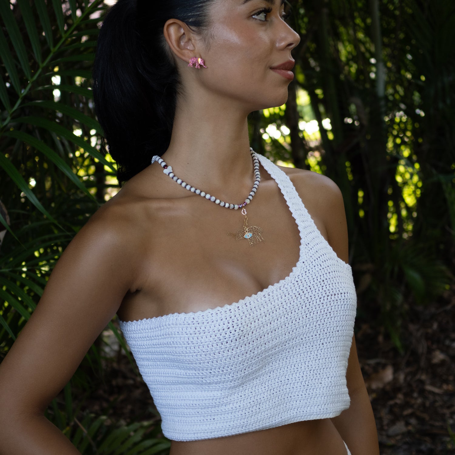 Pearl necklace with colorful hematite beads and gold-plated elephant evil eye charm for protection and luck.​