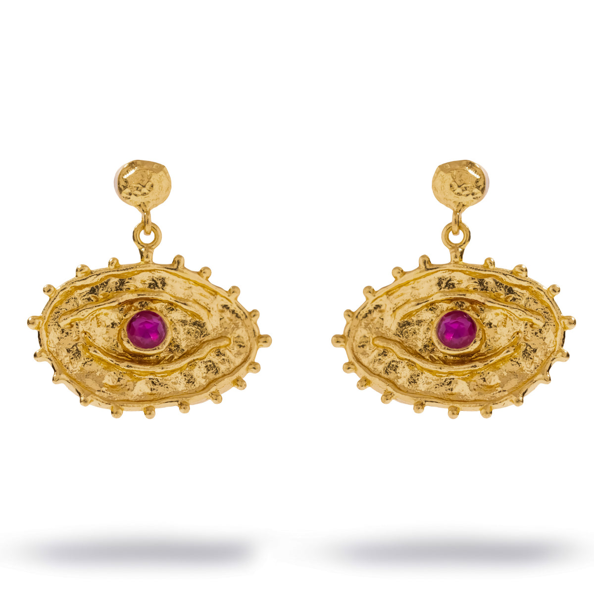 Pair of Sacred Gaze ruby evil eye gold drop earrings on white, a textured gold oval eye with a pink red zircon center and a beaded rim