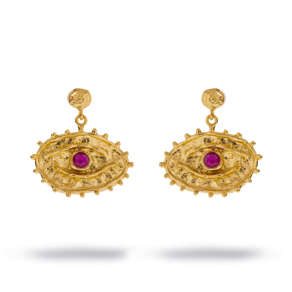 Front studio view of the Sacred Gaze evil eye earrings, the faceted ruby colored zircon set at the center of each textured gold eye