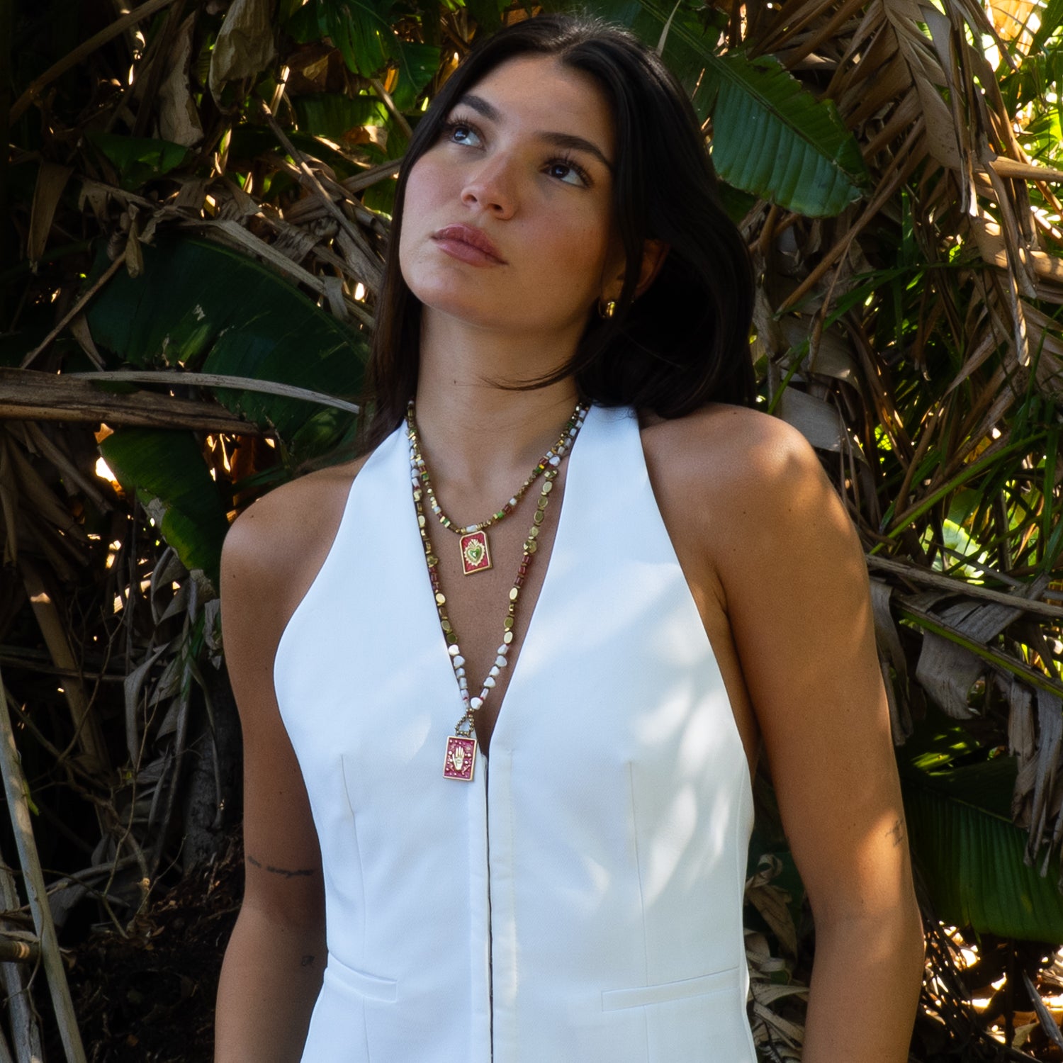 Model wearing Ebru Jewelry sacred hand evil eye protection necklace outdoors