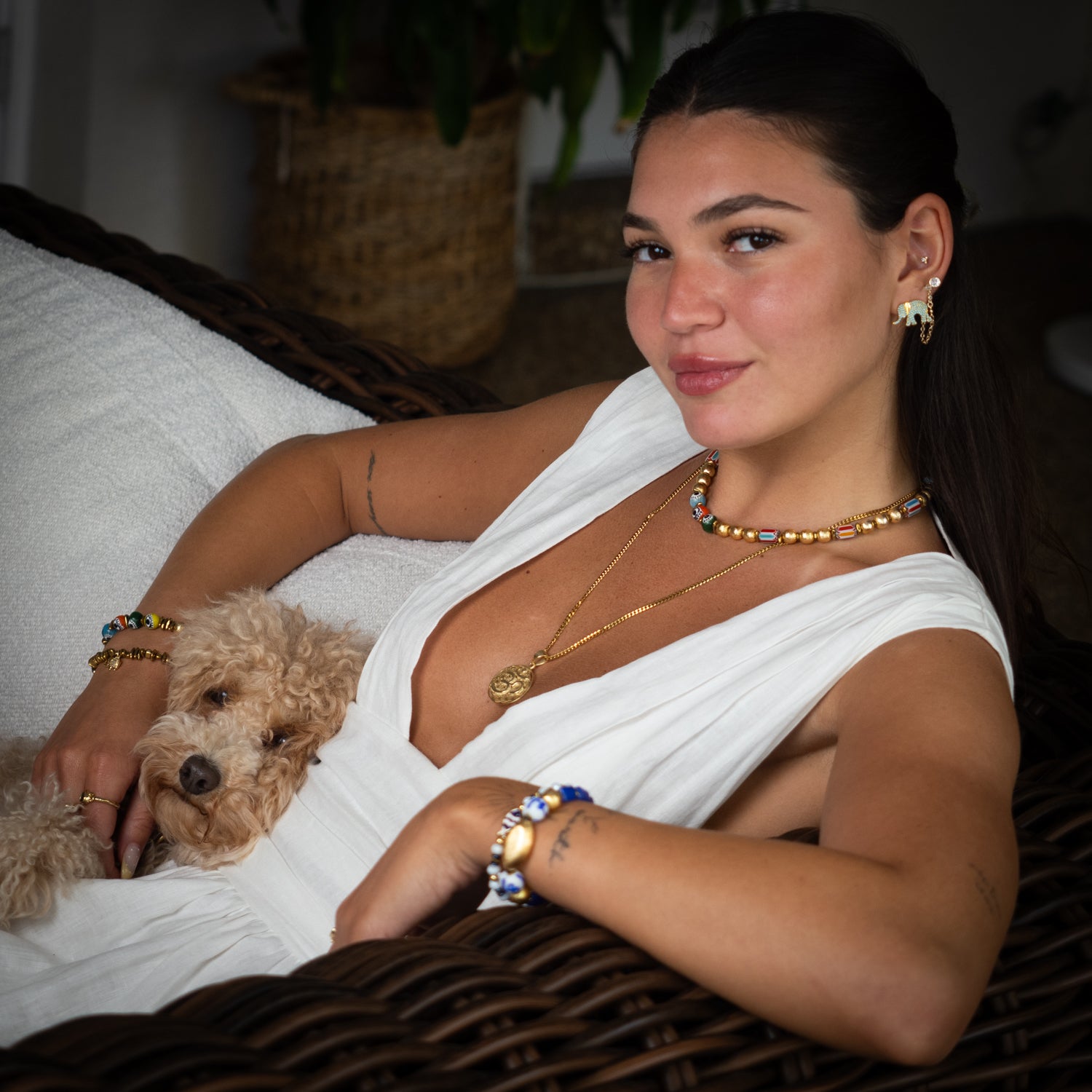 Sacred Om Flower of Life gold talisman necklace styled on white halter dress