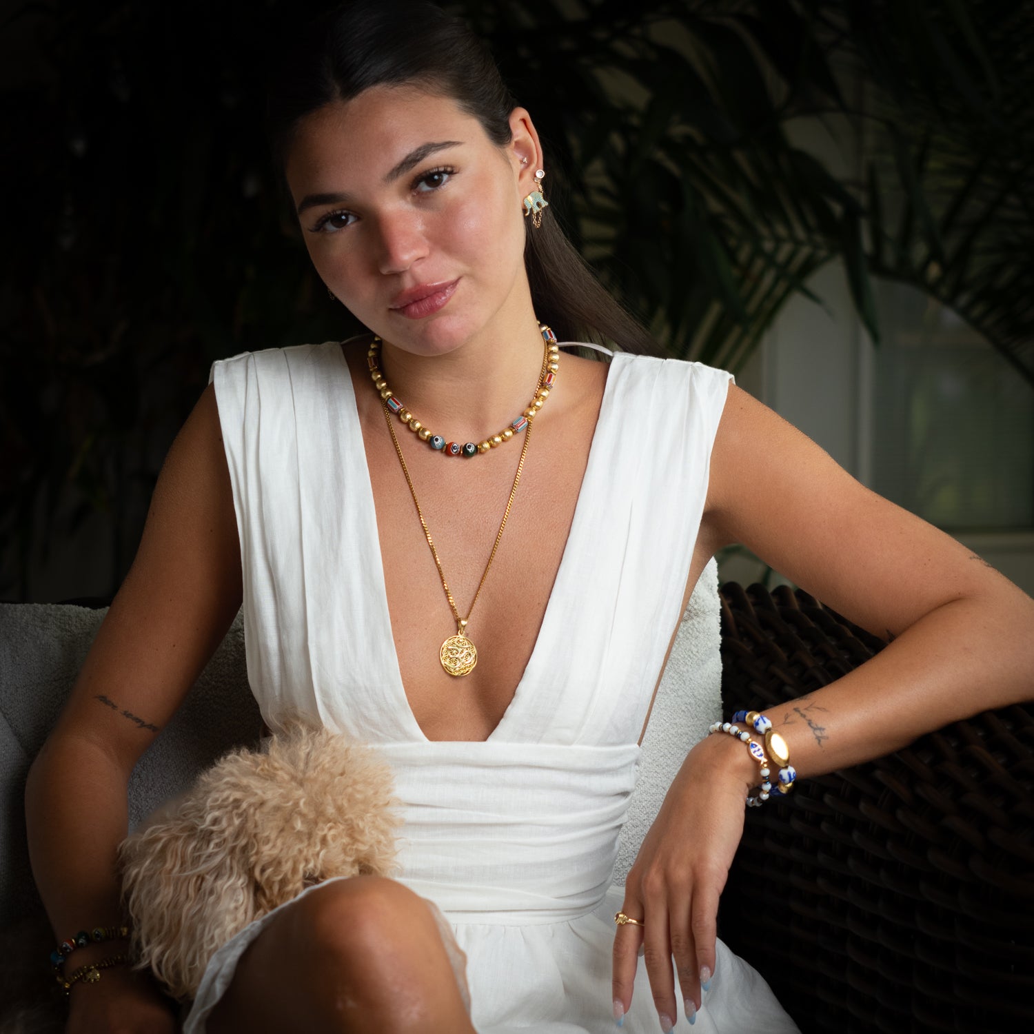 Model wearing handmade gold Om sacred geometry pendant necklace